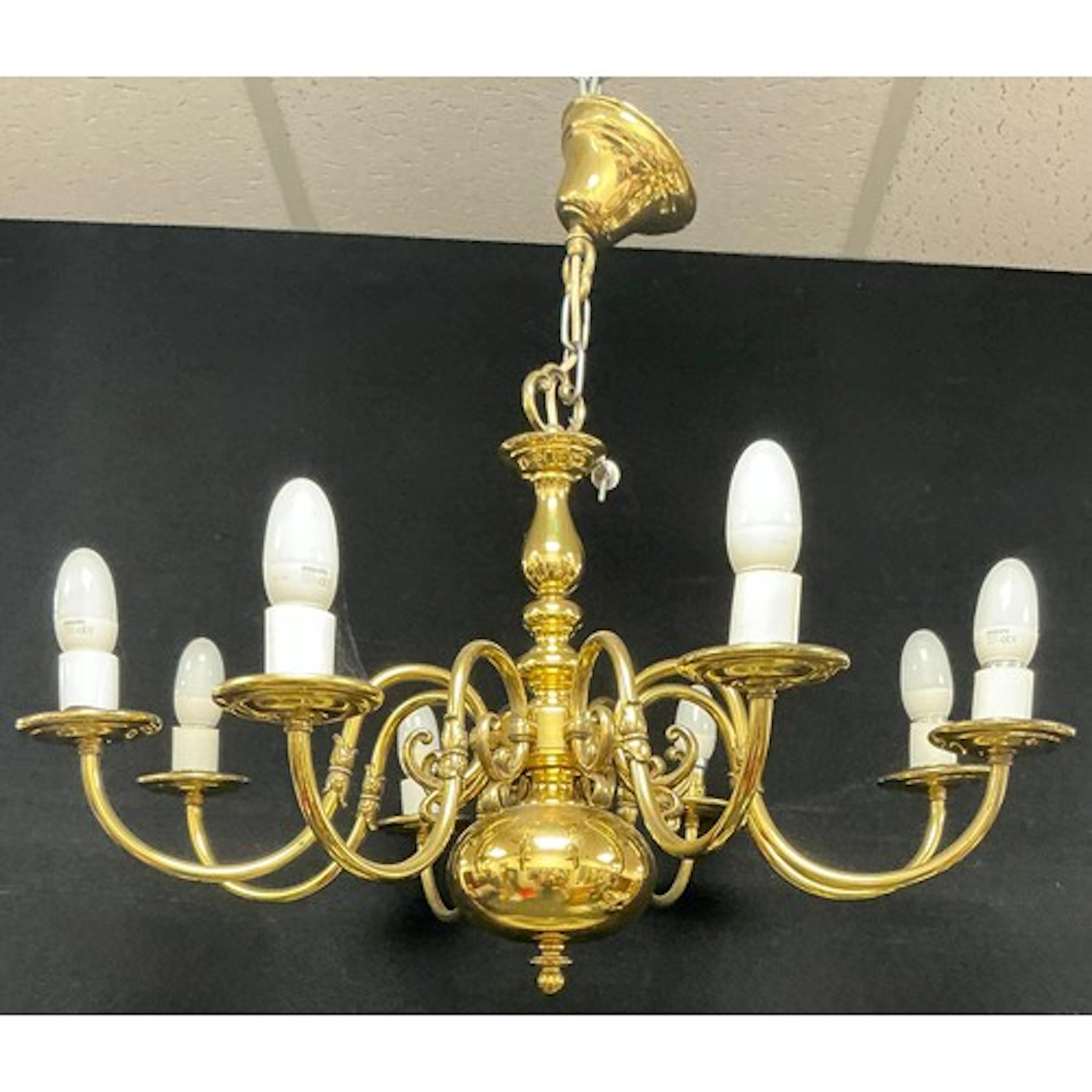 An eight branch chandelier, scrolling brass branches with mo...