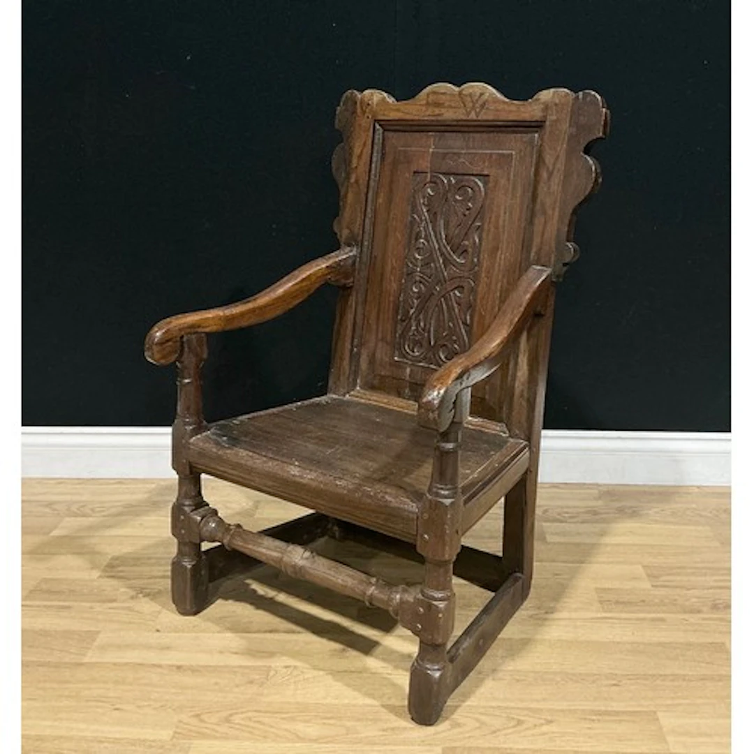 A late Victorian oak wainscot armchair, in the Charles II ta...