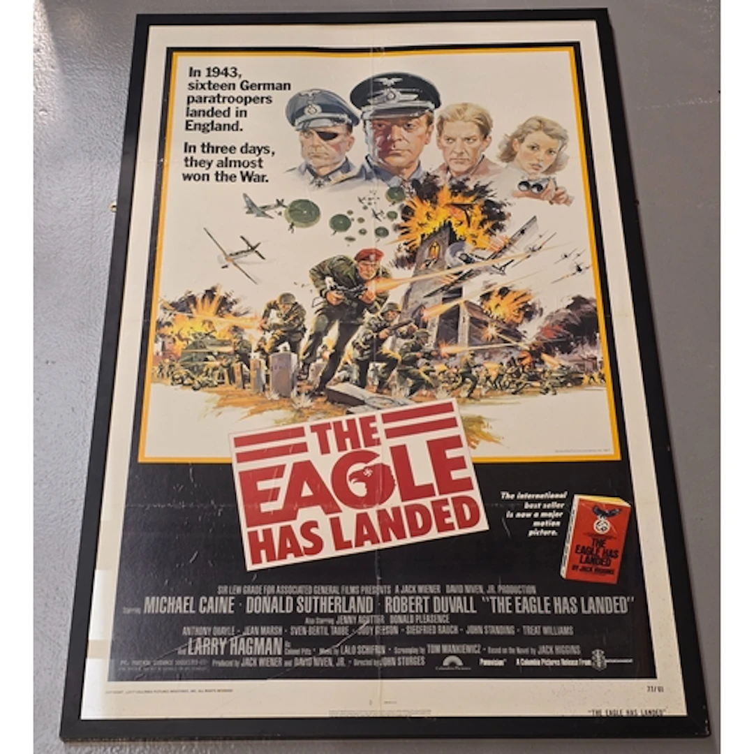 A vintage framed 1977 quad movie poster for "The Eagle Has L...