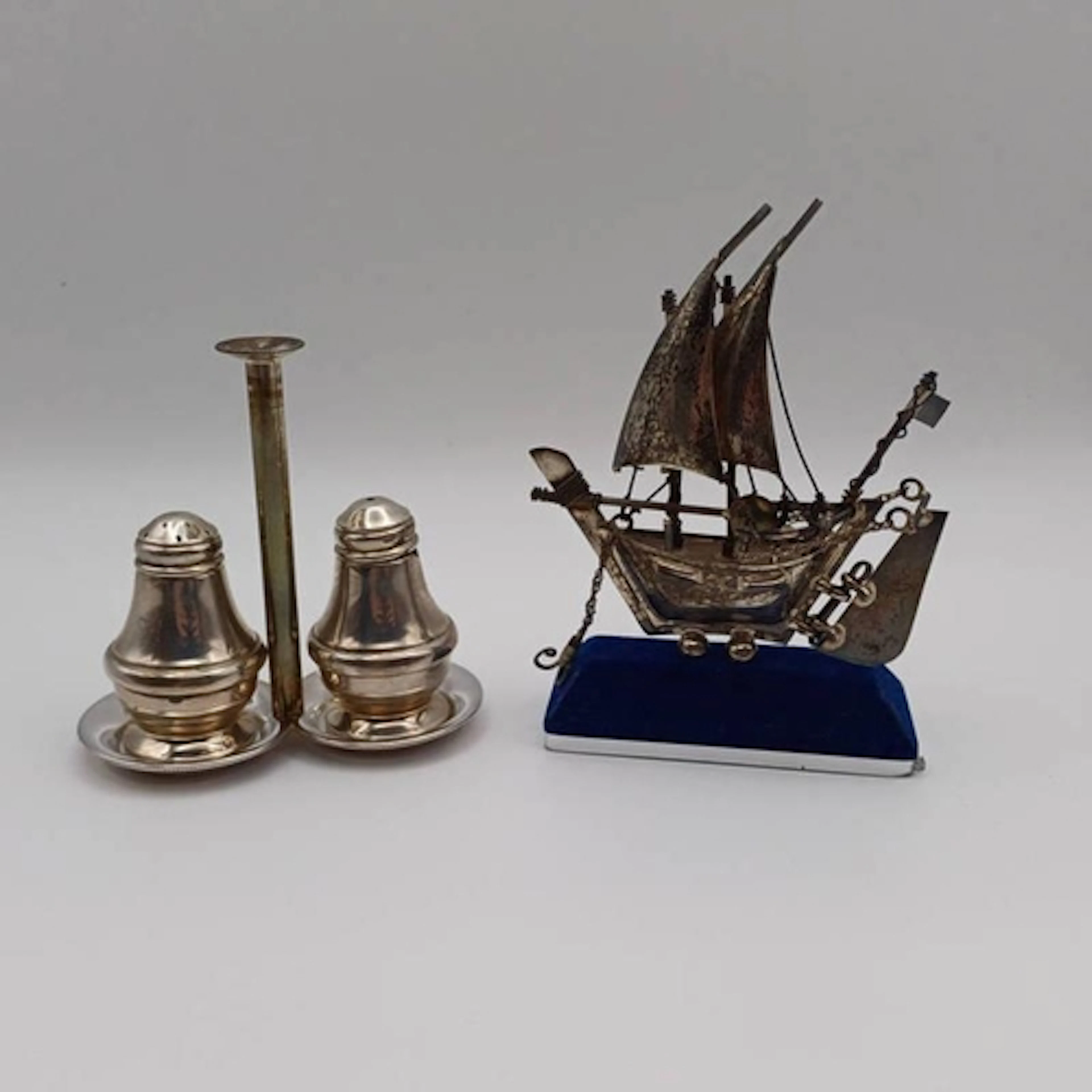 A SILVER SALT & PEPPER IN A STAND BY LAURENCE R WATSON & CO....