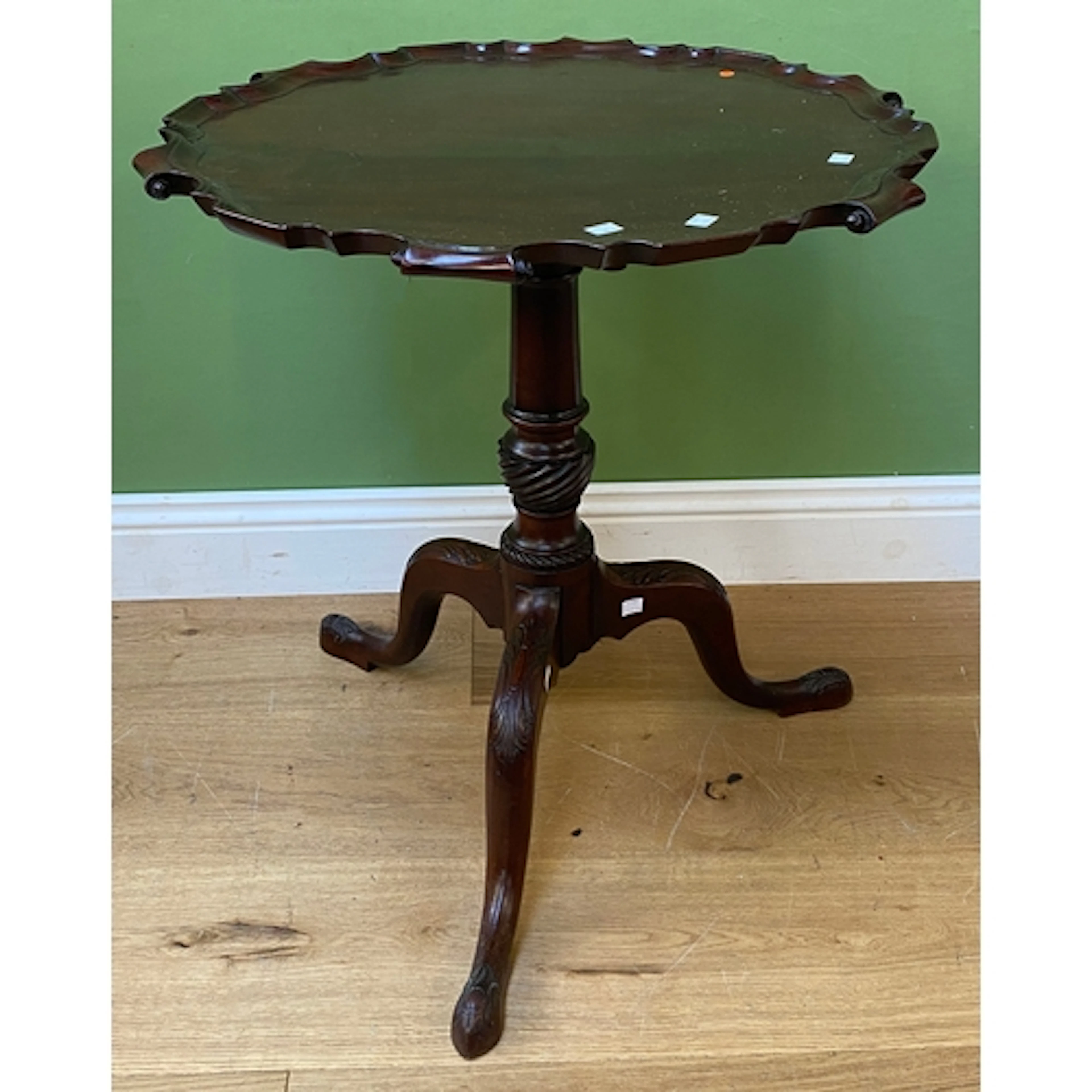 A tilt top mahogany table, the shaped top on a wrythen colum...