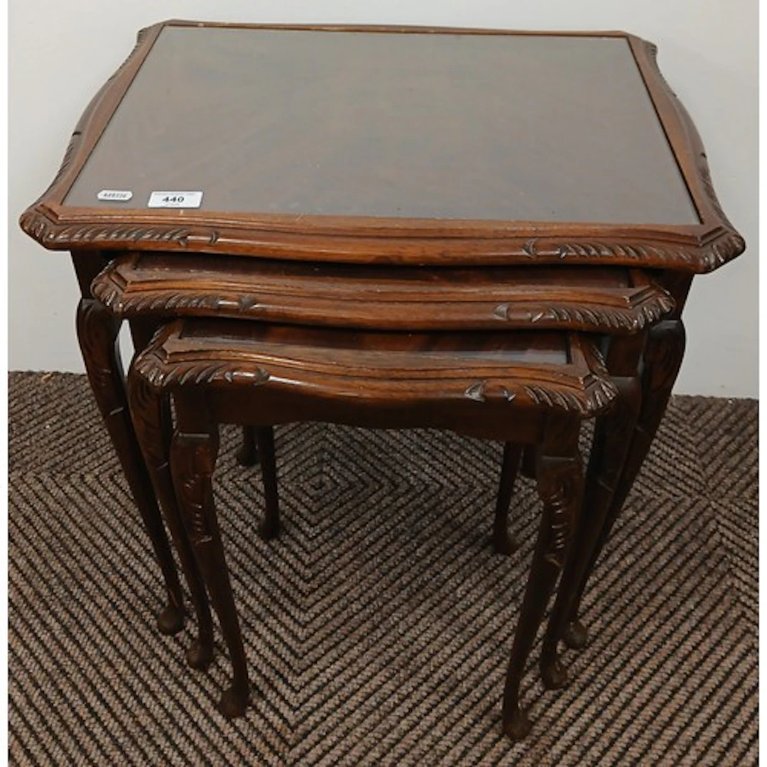 Nest of three mahogany tables raised on cabriole supports.