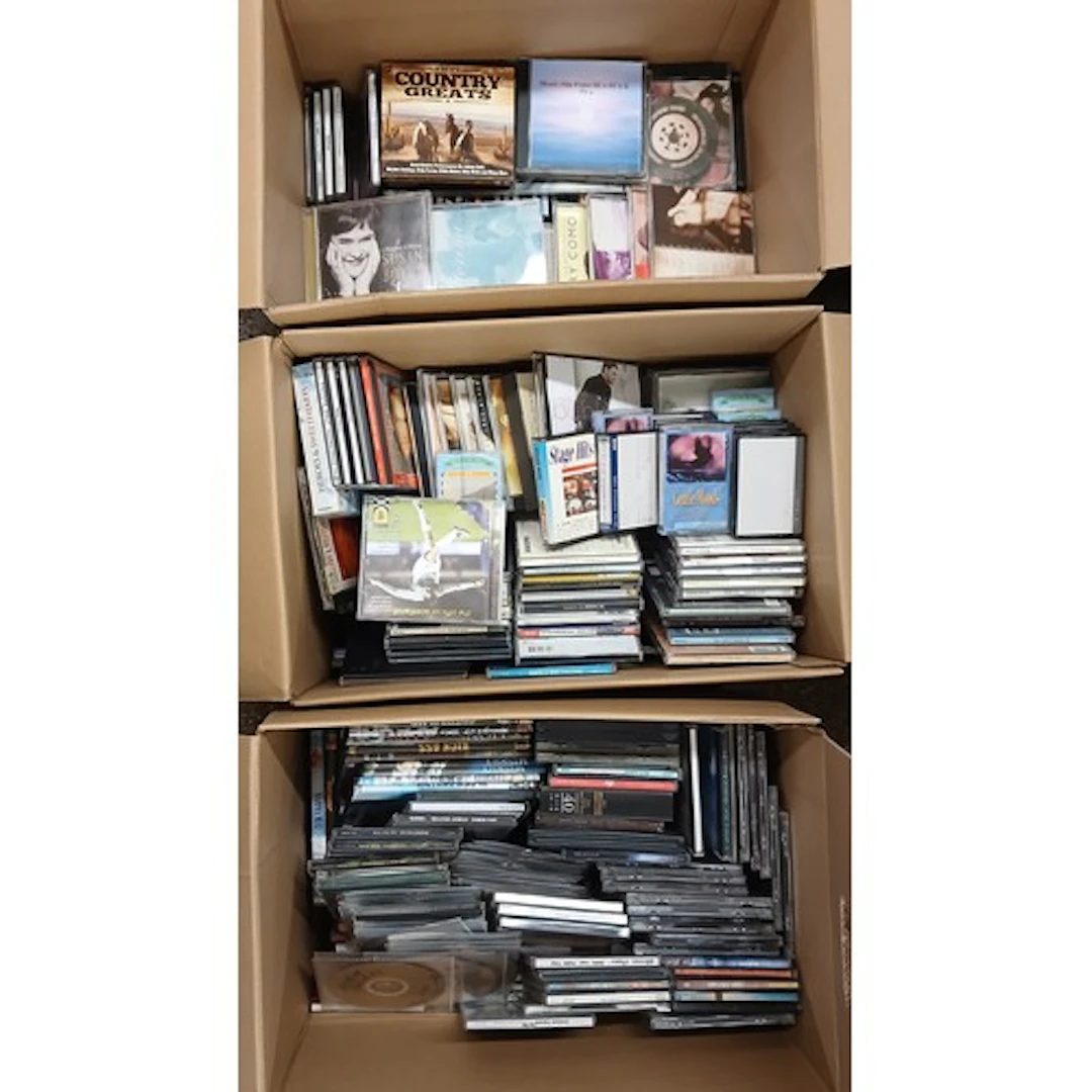 Three boxes of assorted CDs.