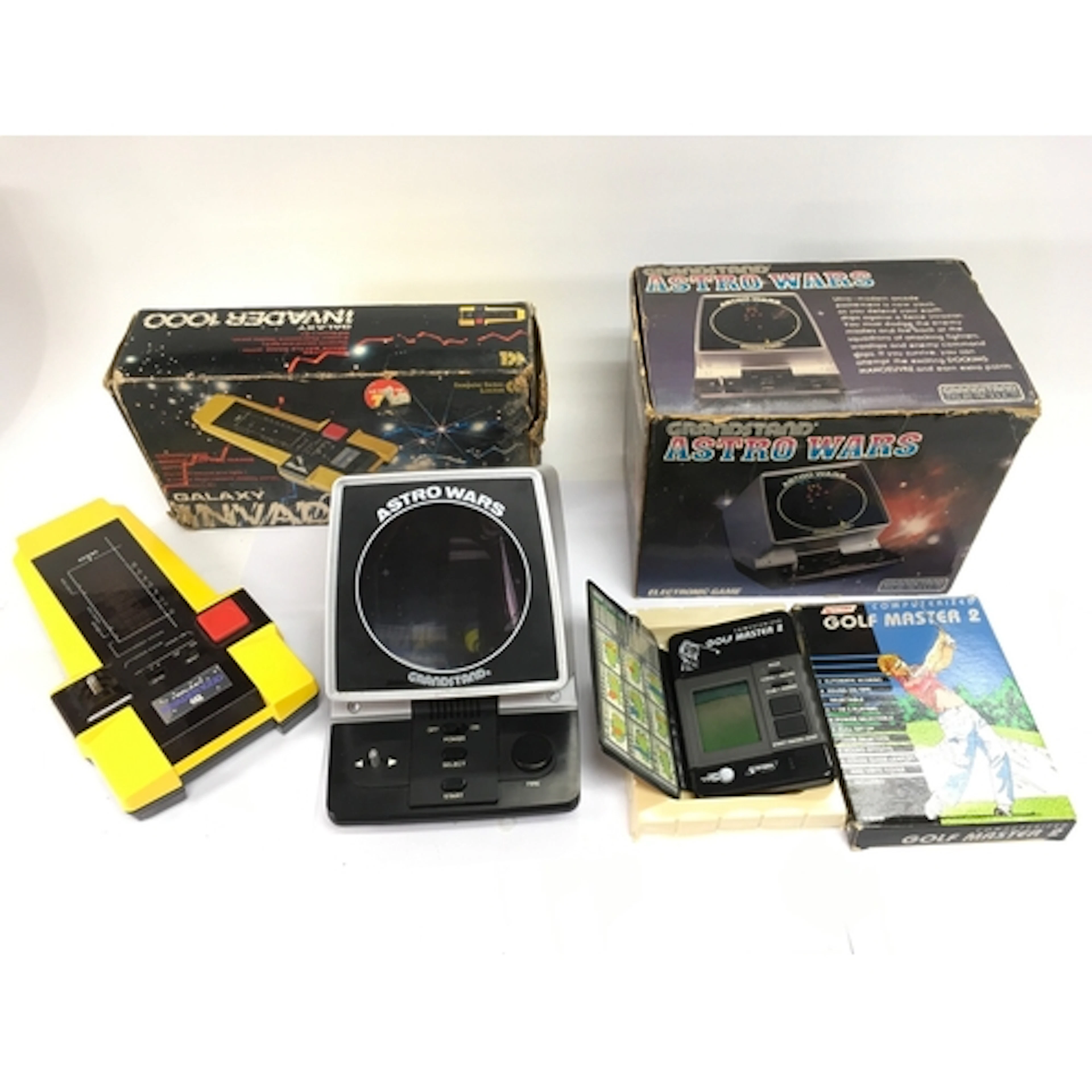 Three boxed vintage electronic games comprising a Grandstand...