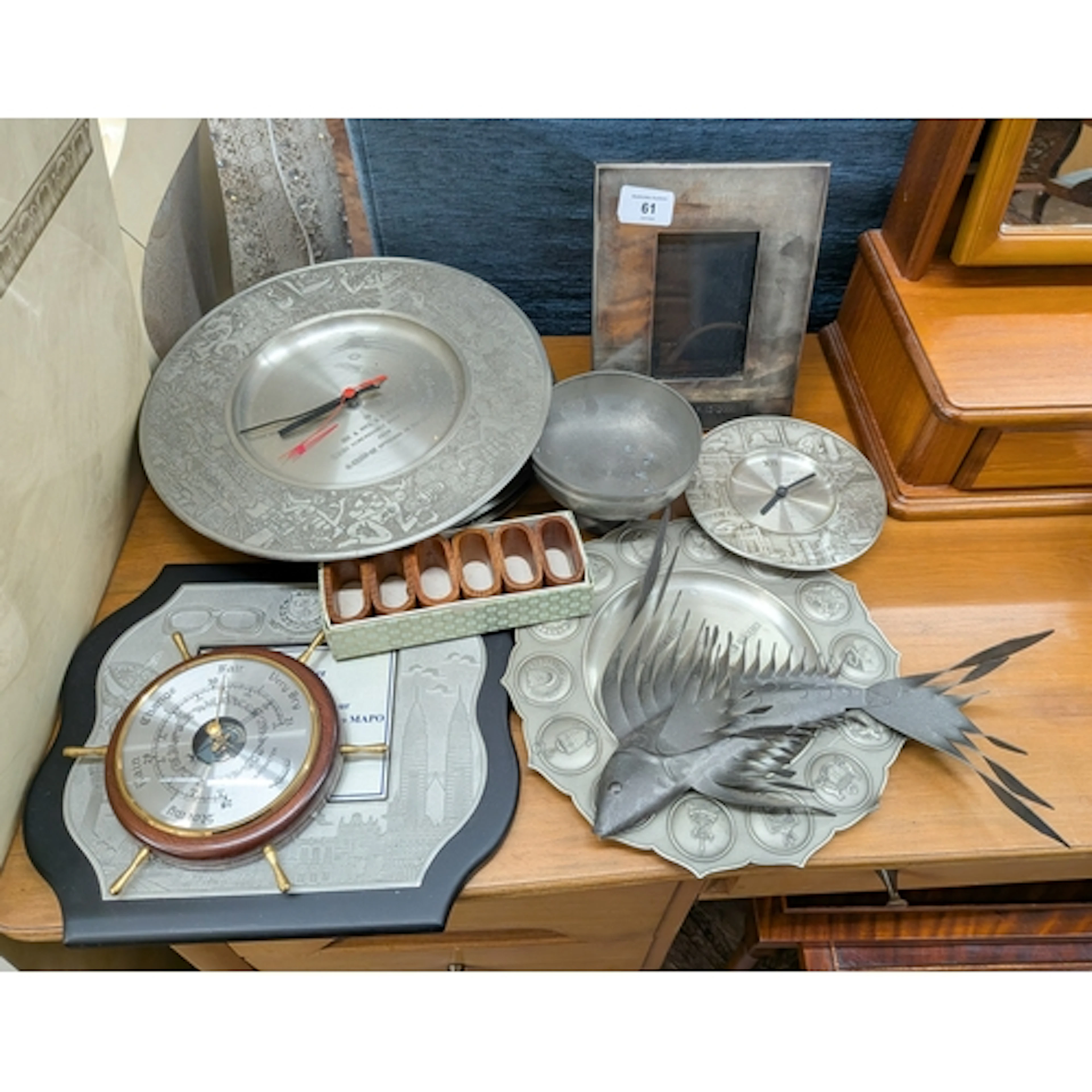 A pewter wall clock together with pewter plates, photo frame...