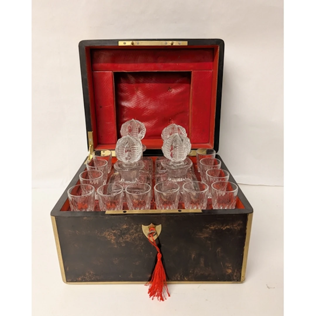 A 19th century simulated coromandel and brass bound decanter...