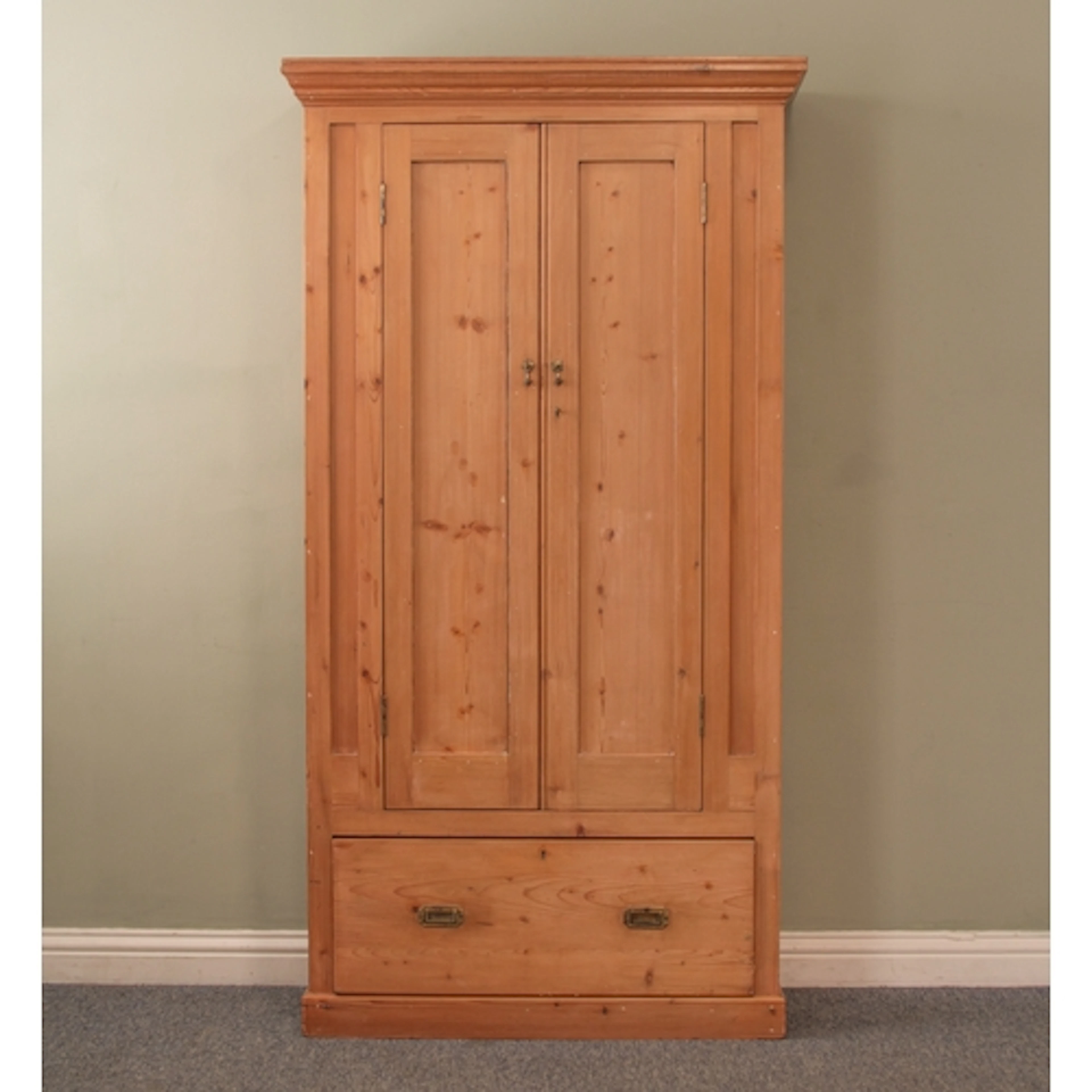 A waxed pine single wardrobe - the moulded cornice over two ...