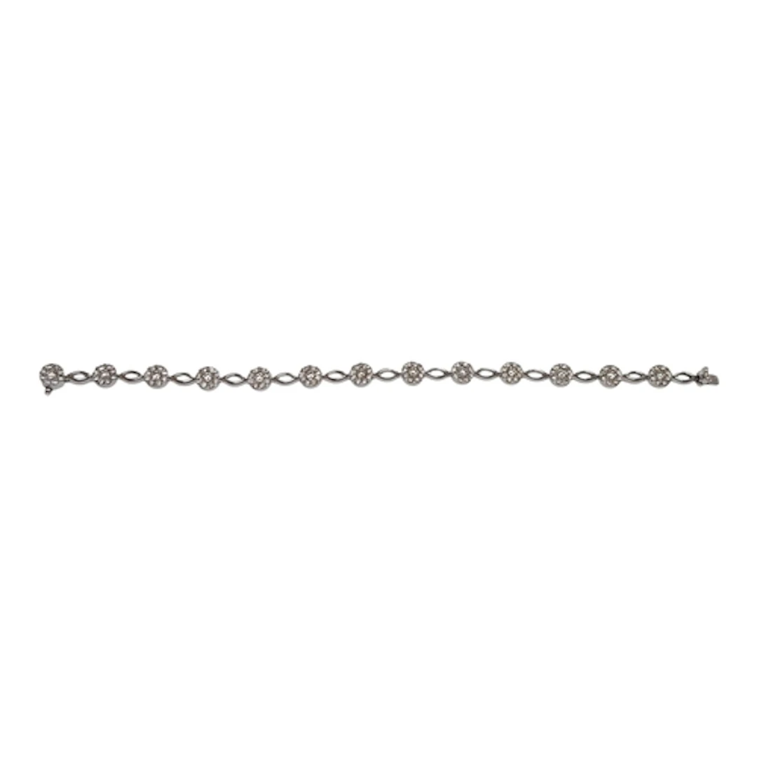 A modern 14k and diamond bracelet, set with thirteen diamond...