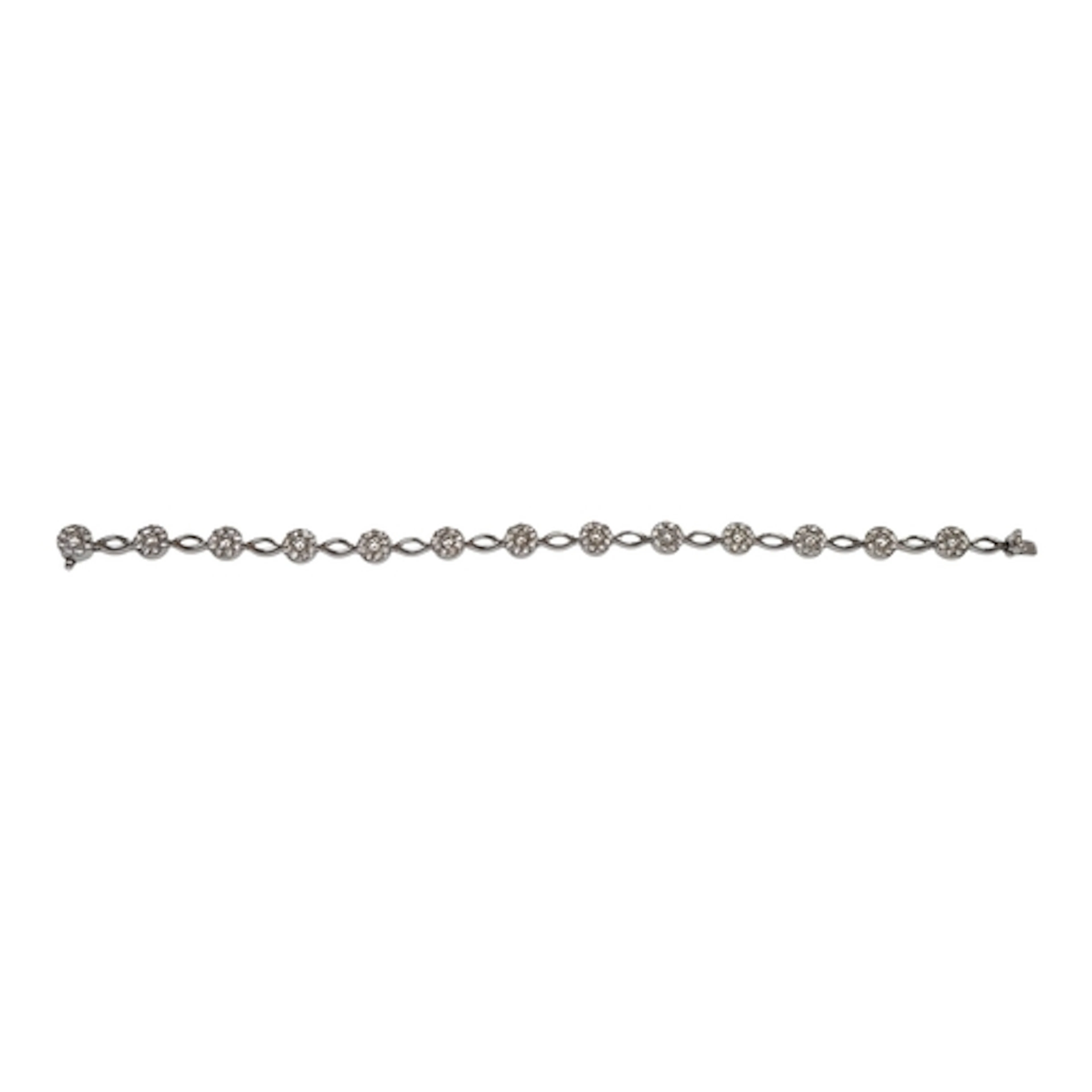 A modern 14k and diamond bracelet, set with thirteen diamond...