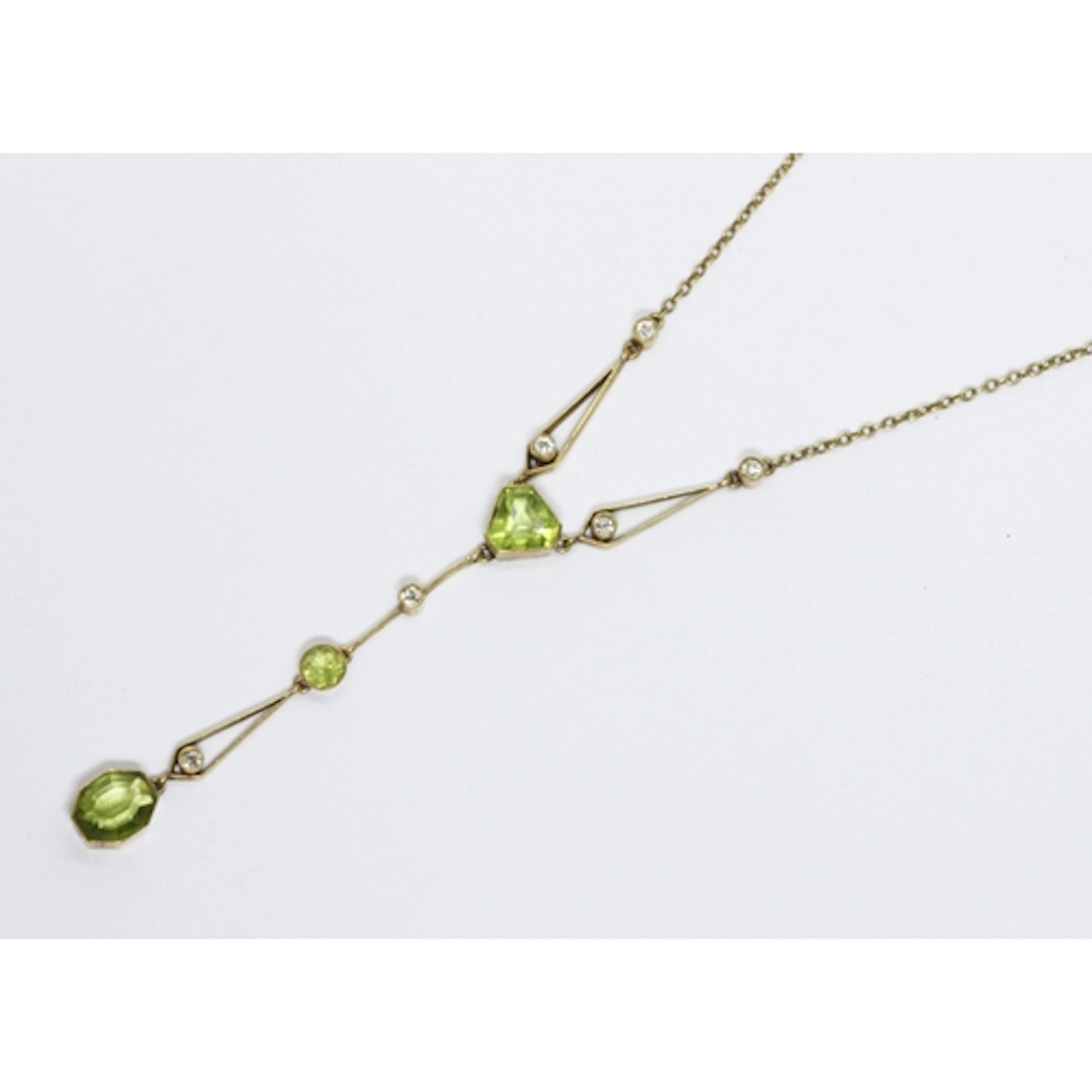 An antique peridot and diamond pendant necklace, pendant len...