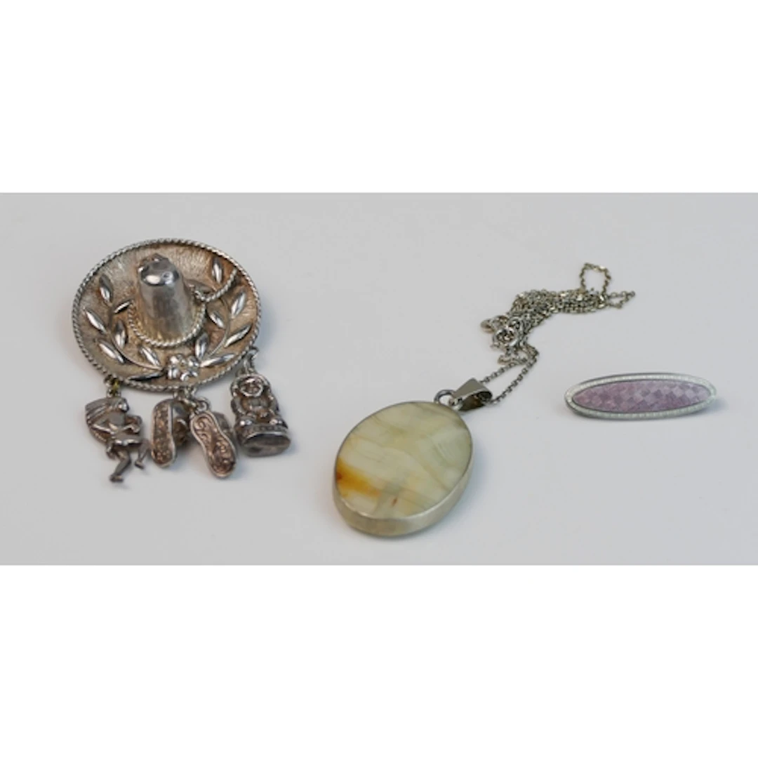 A silver Mexican hat pendant, silver guilloche brooch and a ...