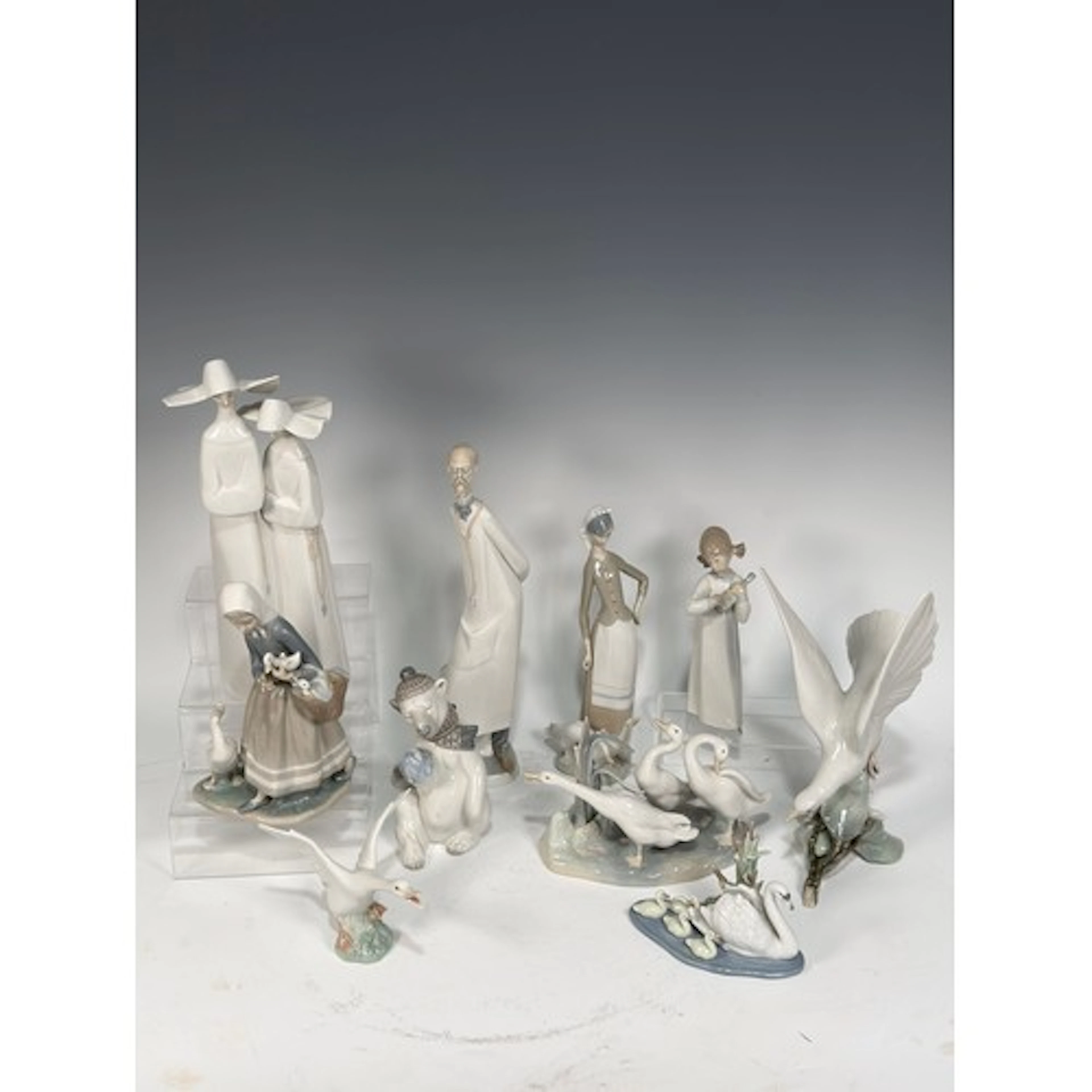 A collection of ten Lladró Figures, to include a Nun figural...