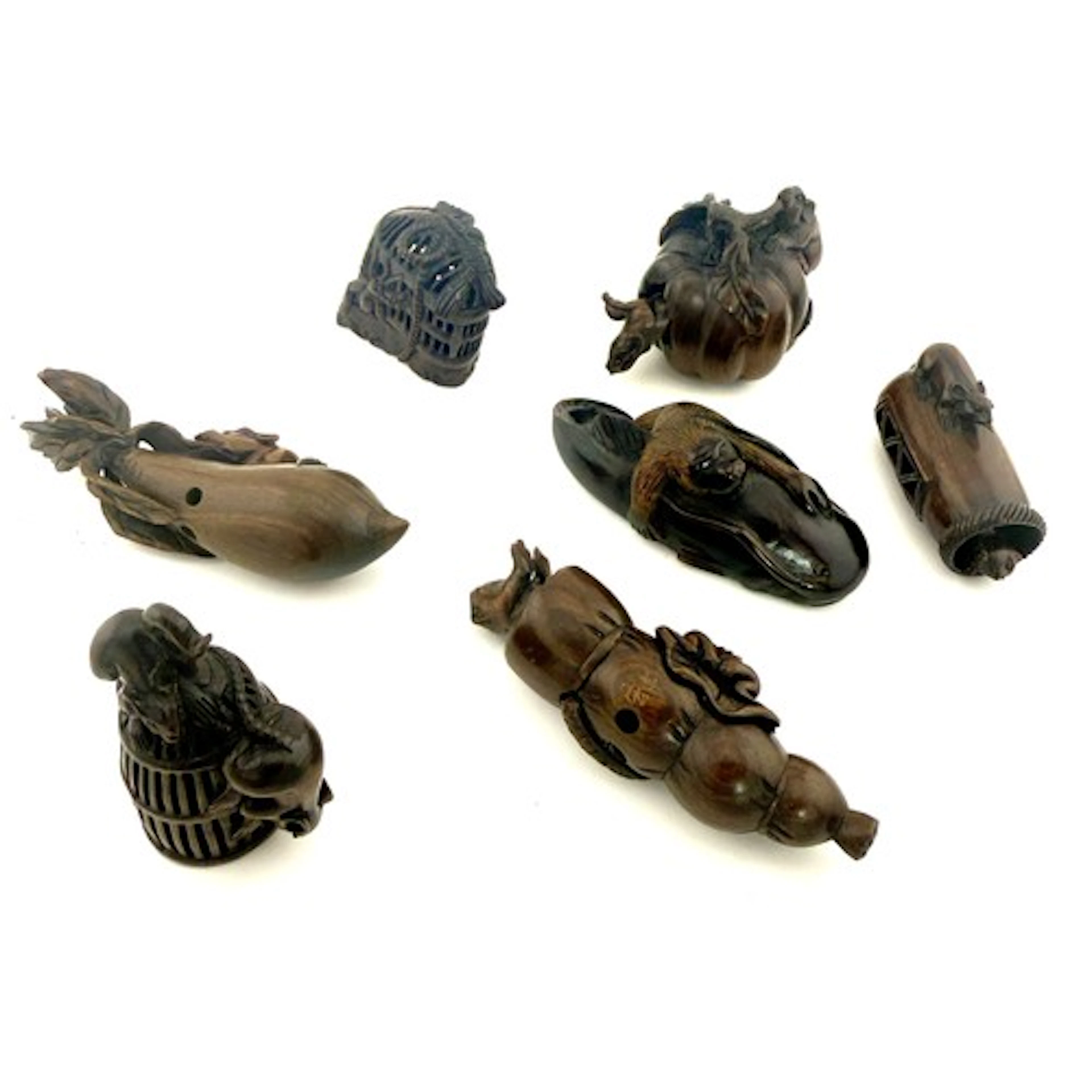 Seven 20thC various hand carved hardwood netsukes.