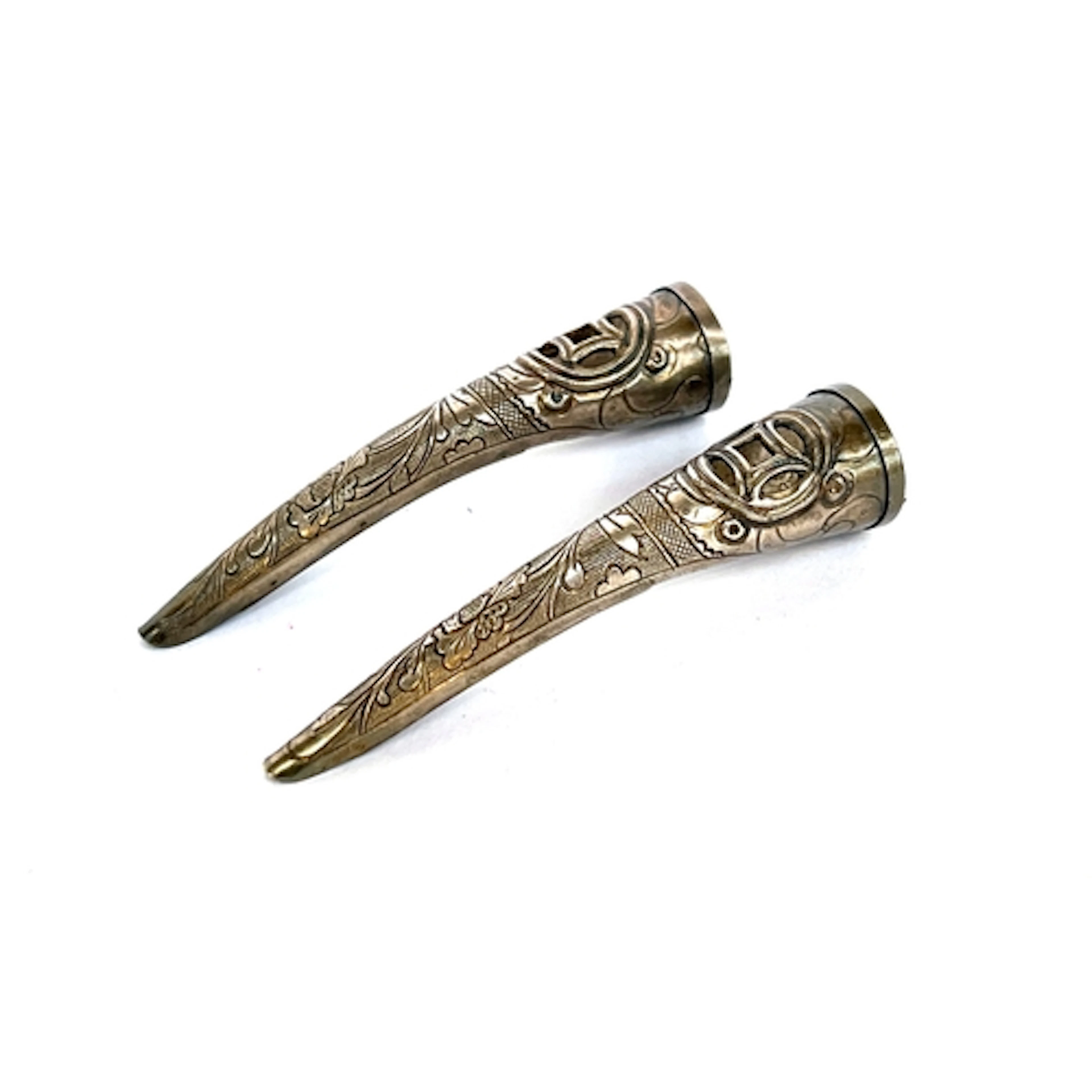 A pair of antique Chinese white metal fingernail guards, wit...