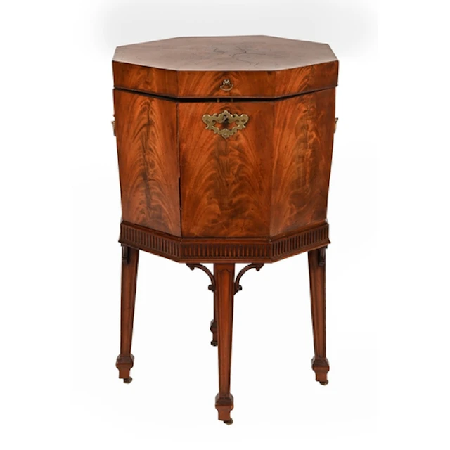 A octagonal mahogany cellarette, 19th c, with figured, cross...