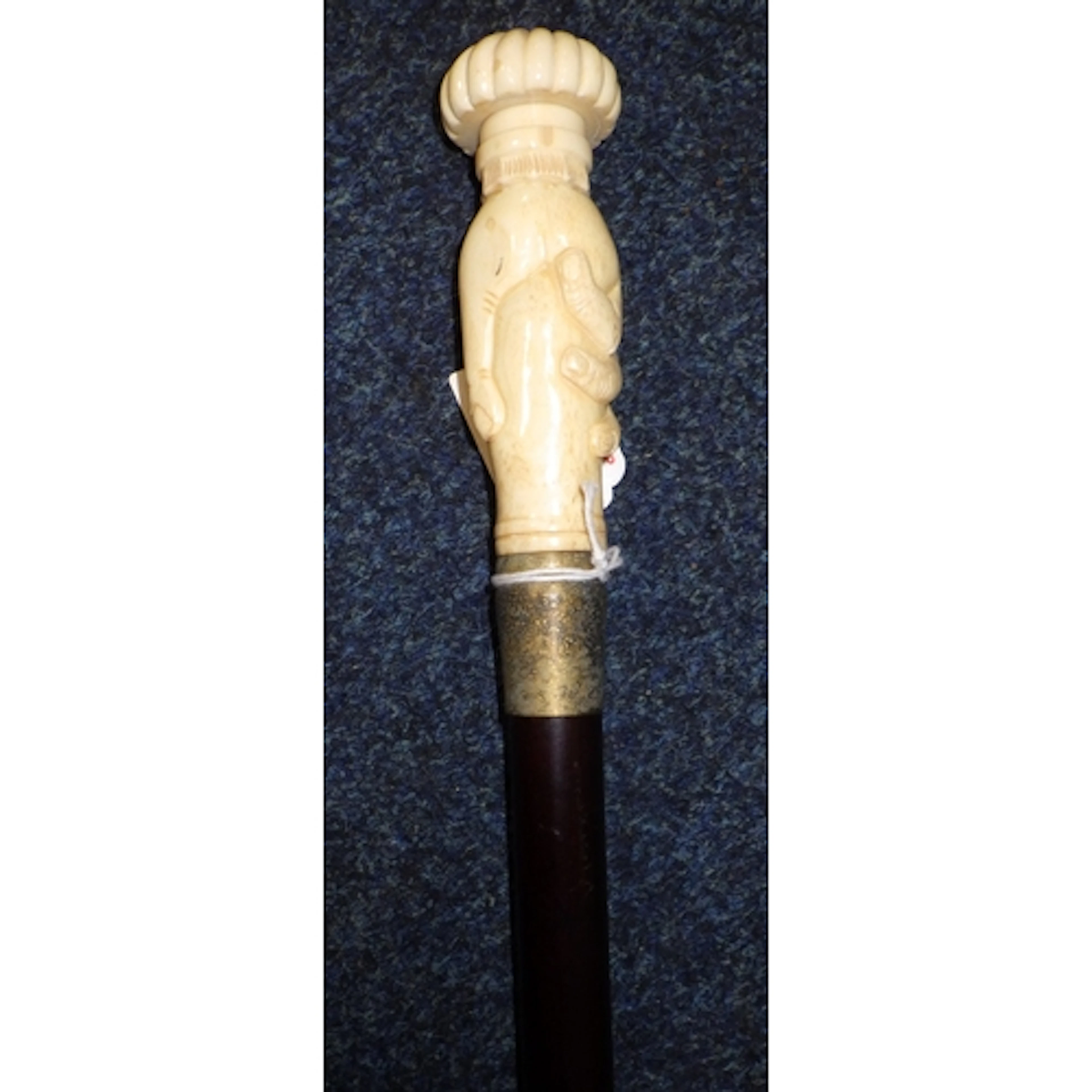 A bone handled walking stick with handle in the form of a ha...