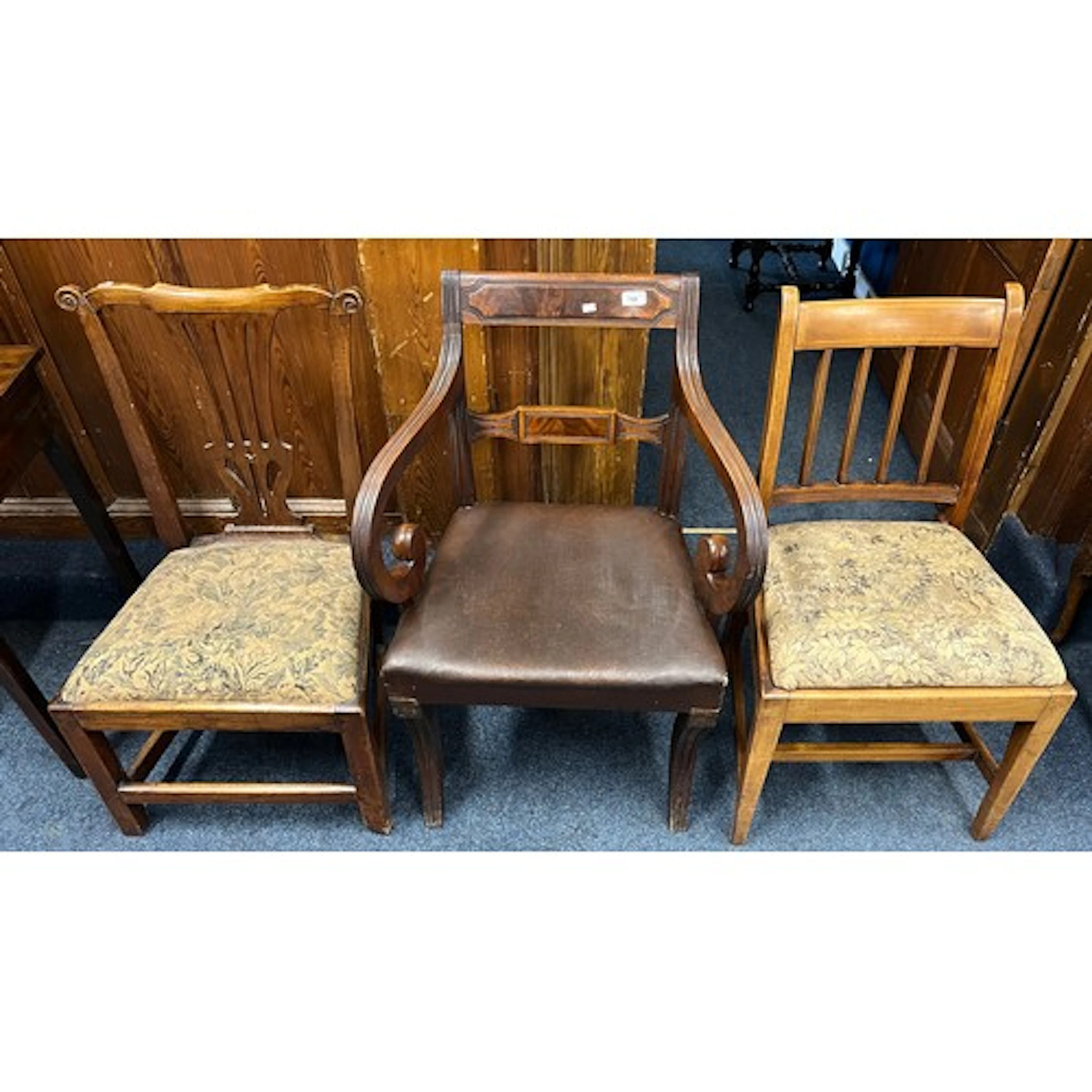Mahogany scrolling armchair and two other dining chairs.