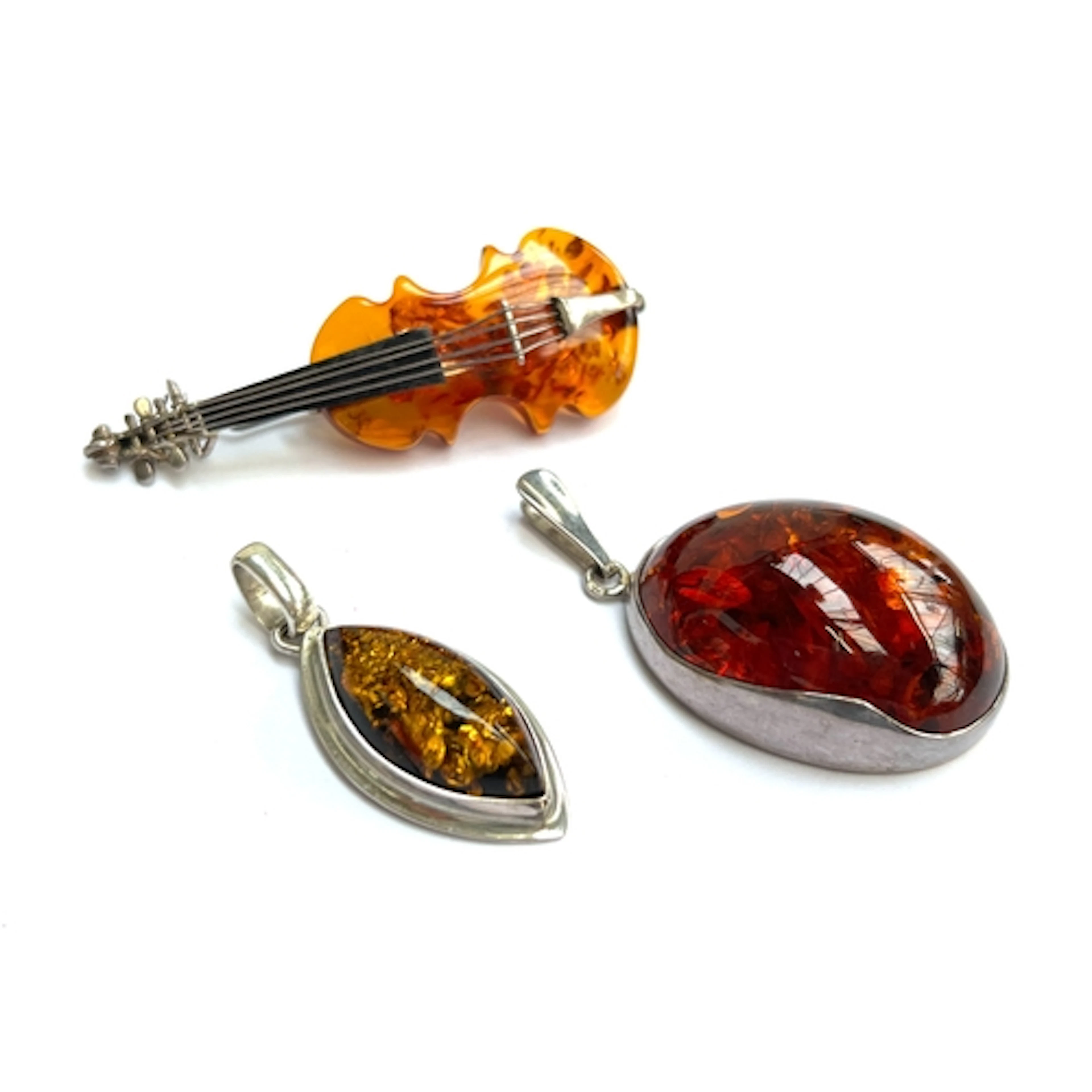 Two 925 silver and amber pendants together with a 925 silver...