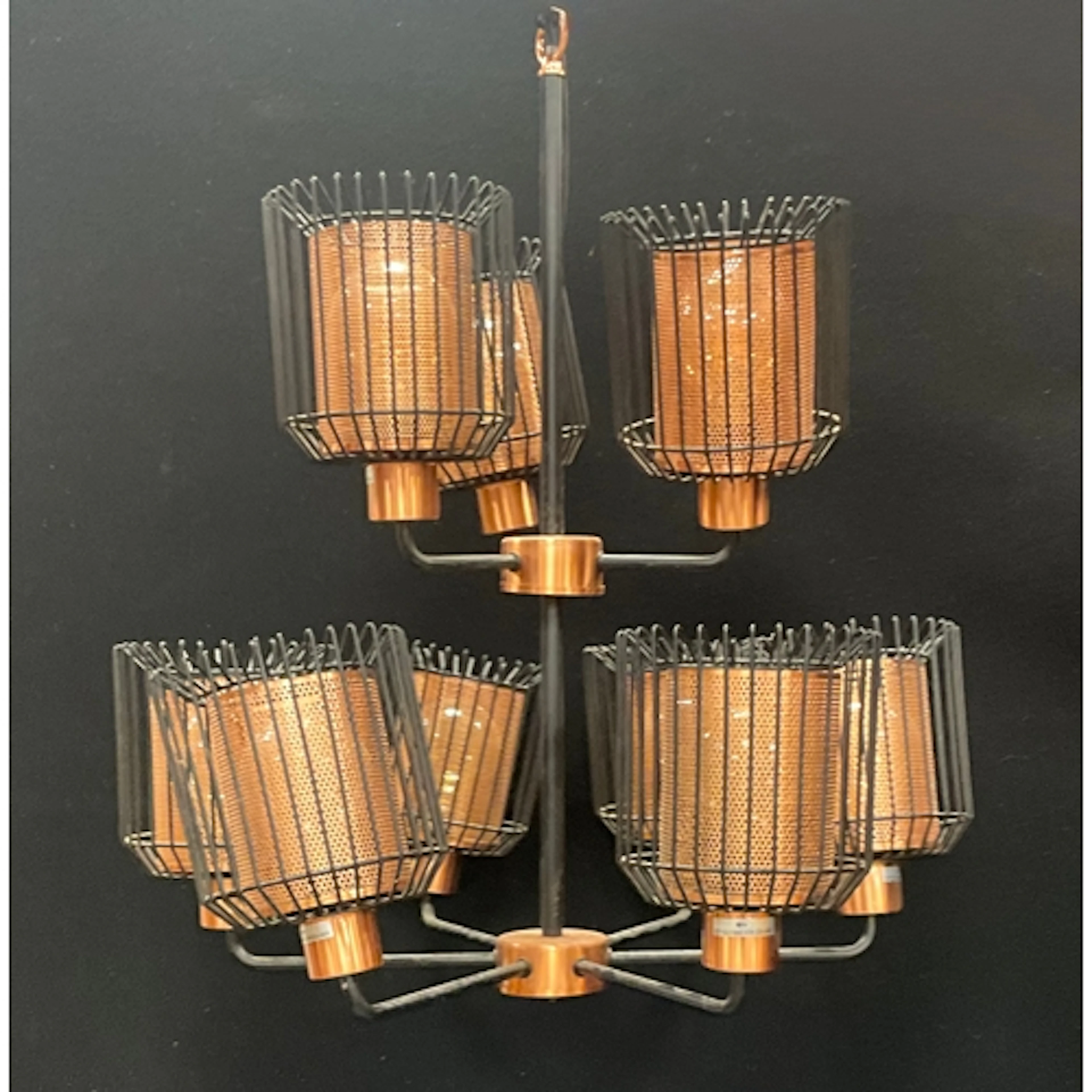 A contemporary two tiered chandelier with black metal framed...