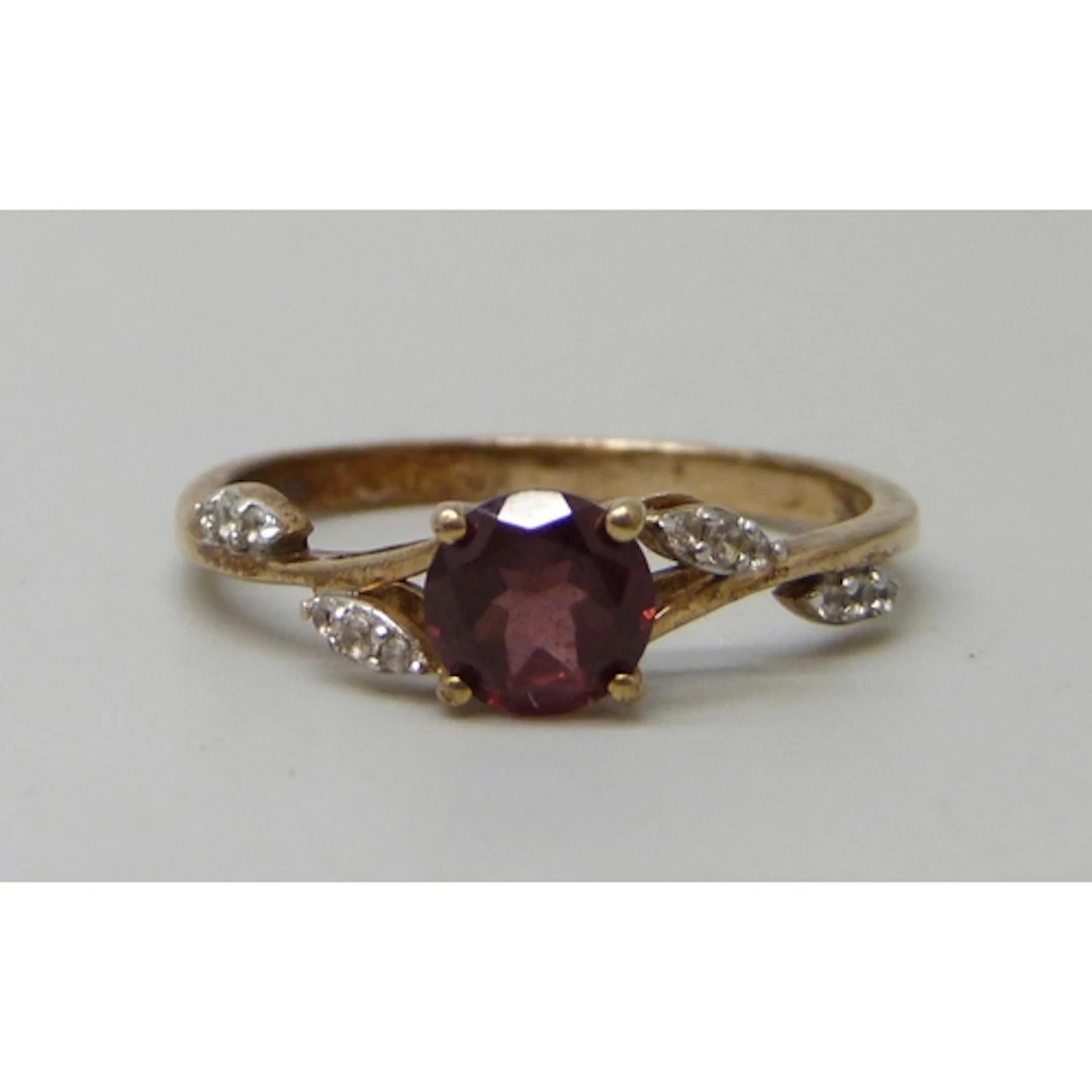 A 9ct gold, garnet and white stone ring, 2.3g, S