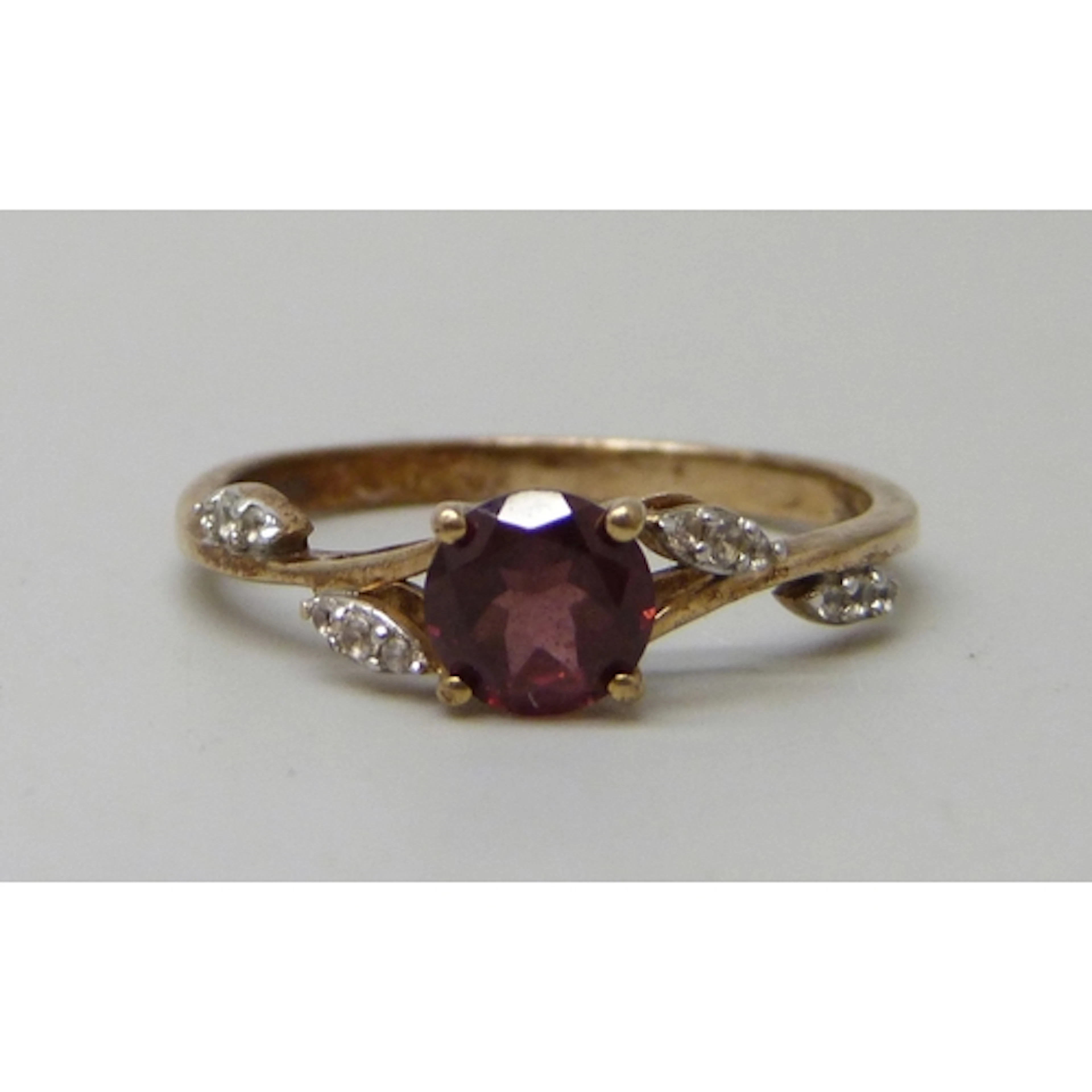 A 9ct gold, garnet and white stone ring, 2.3g, S