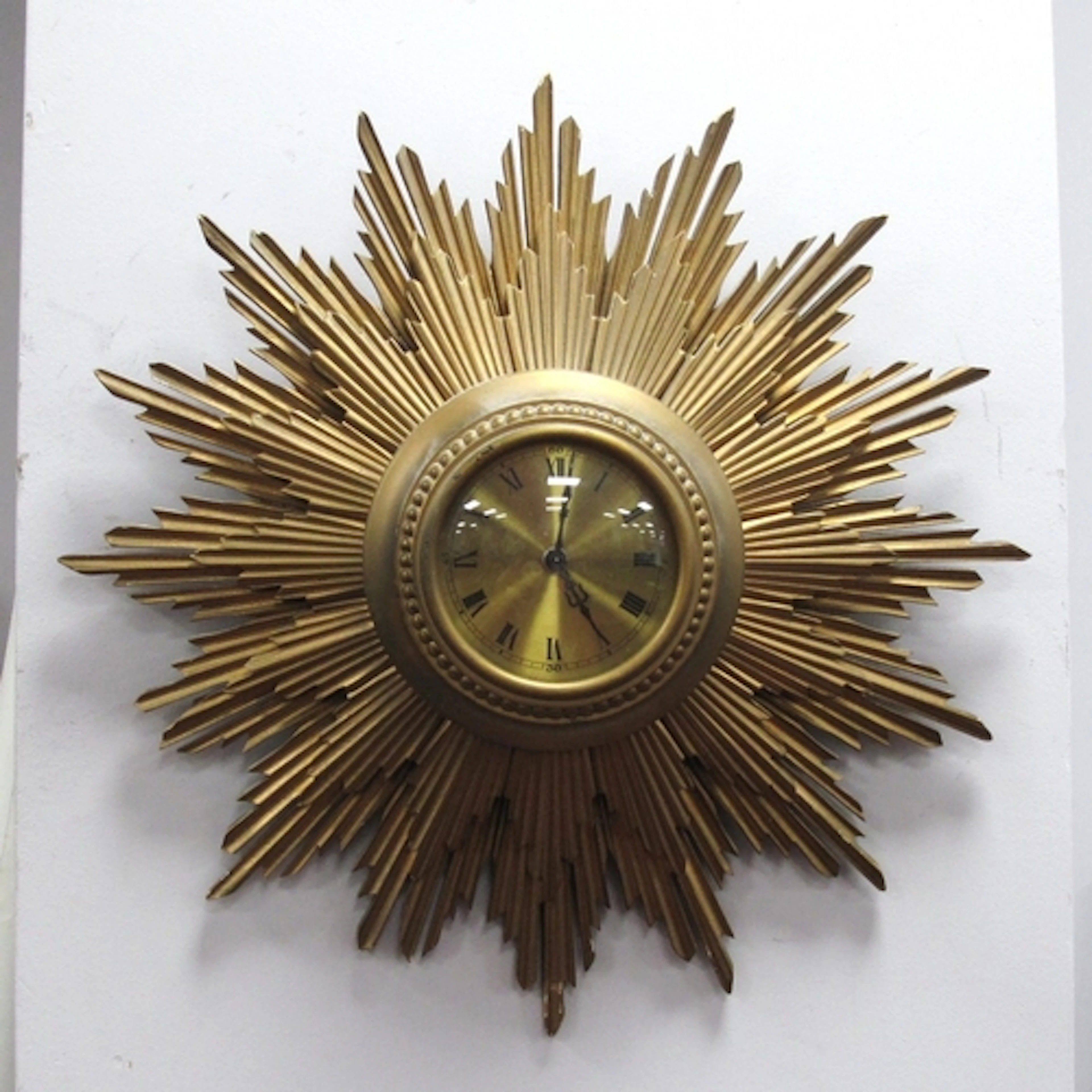 Gilt Wood Sunburst Wall clock, with black Roman numerals to ...