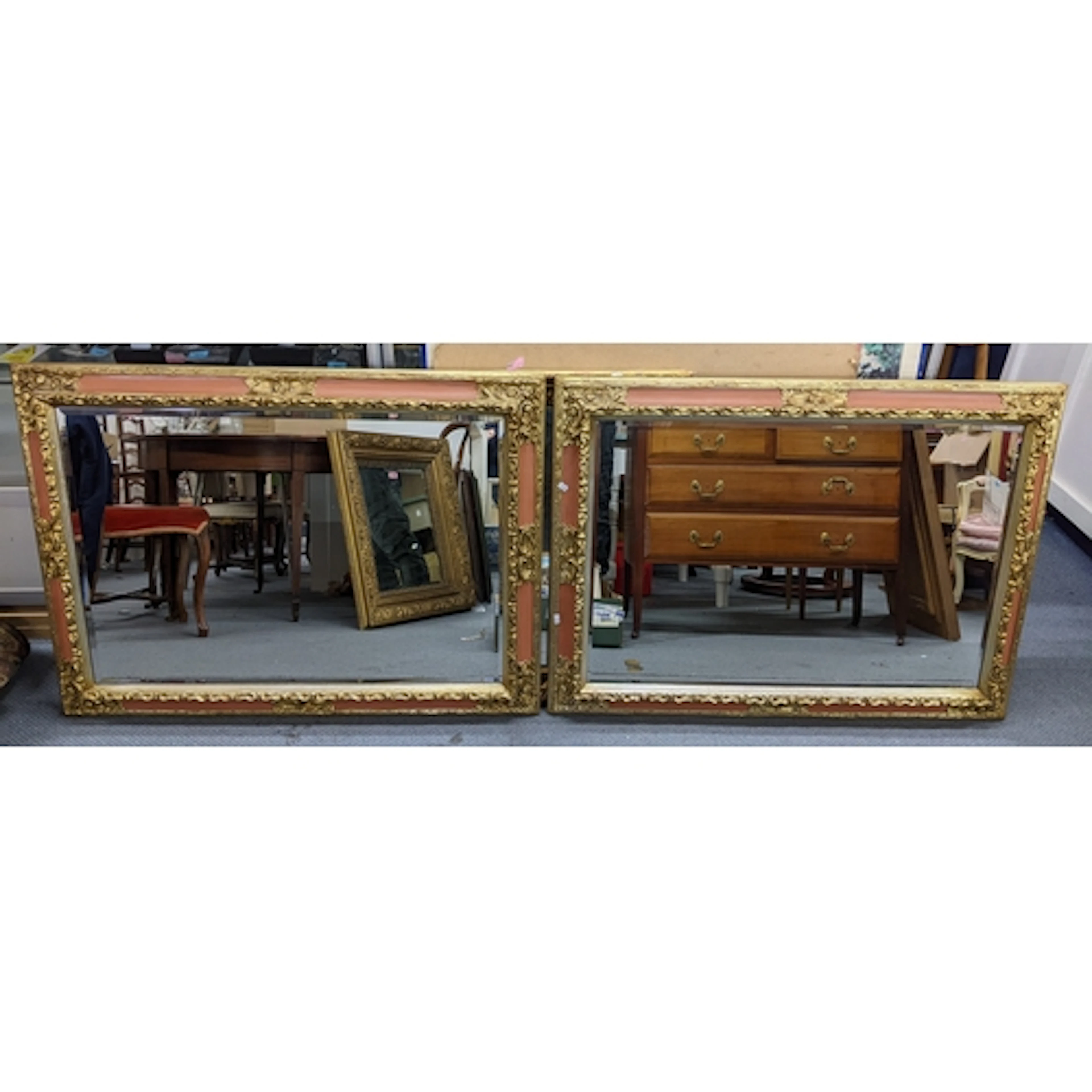 A pair of modern gilt moulded and painted mirrors having bev...