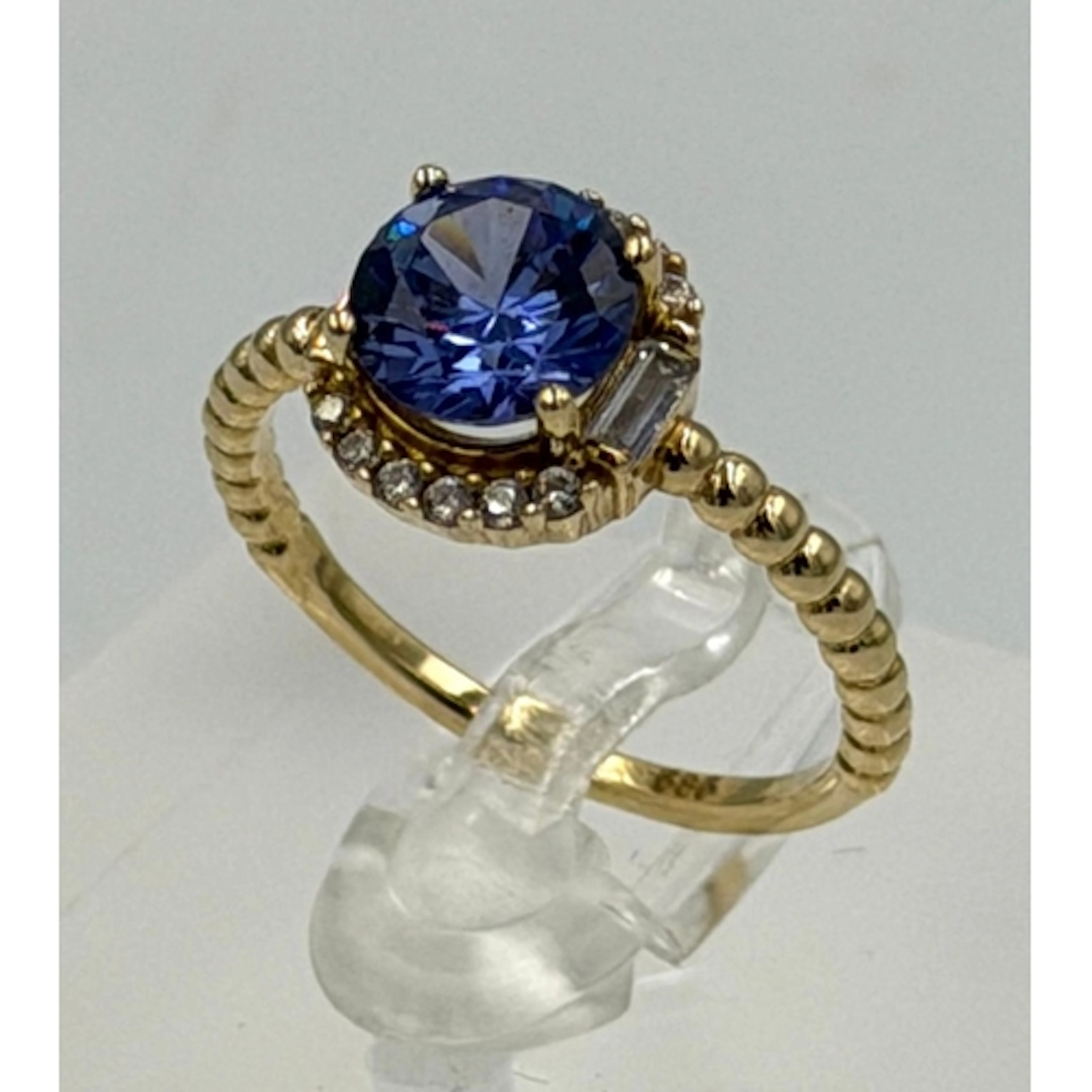 A 15ct yellow gold tanzanite and diamond halo ring, approxim...