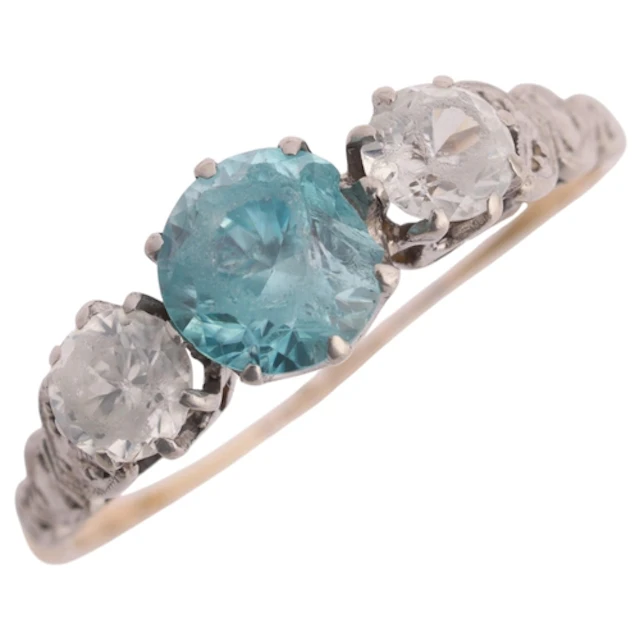 An 18ct gold three stone zircon ring, palladium-topped, claw...