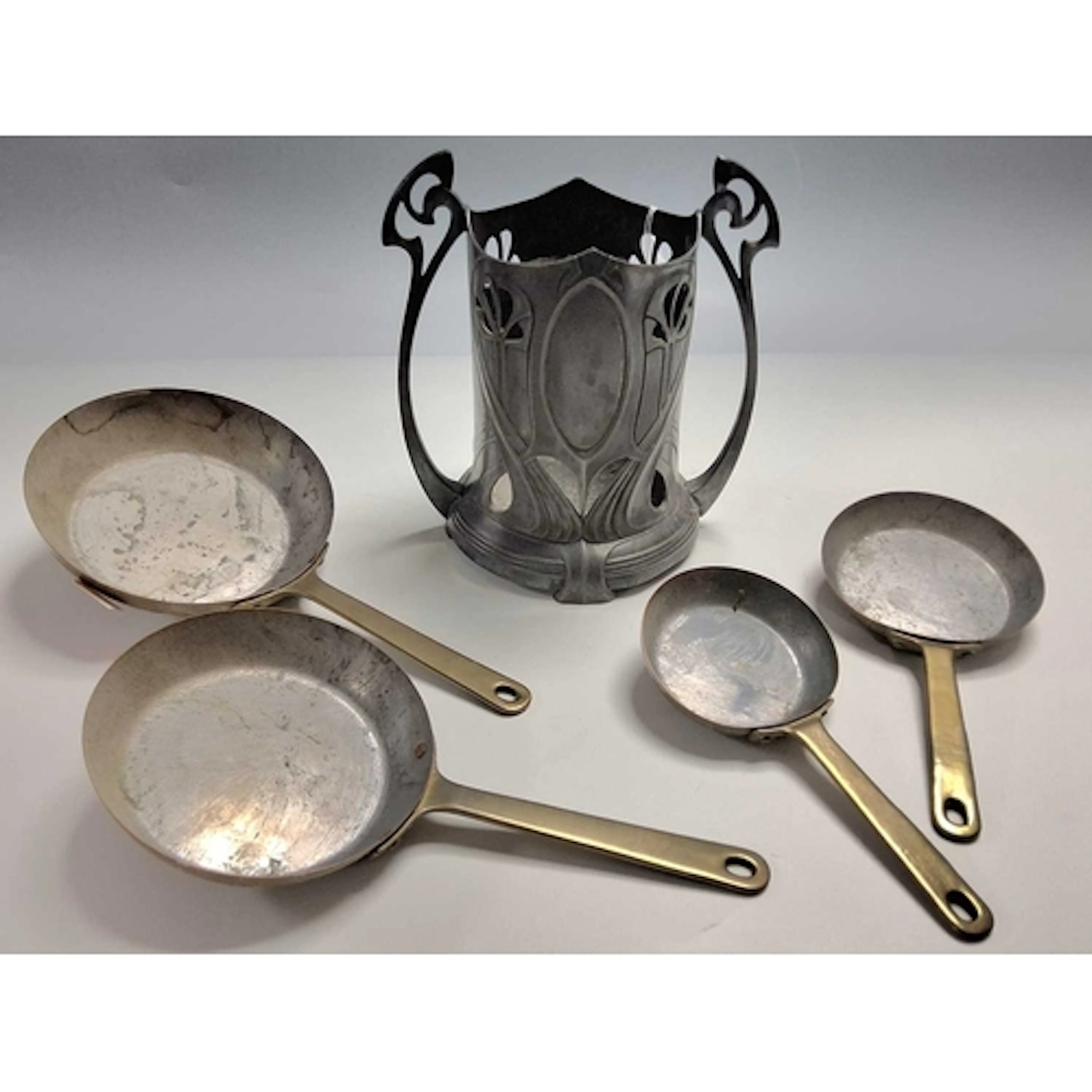 A WMF PEWTER BOTTLE STAND AND A SET OF SMALL COPPER PANS, th...