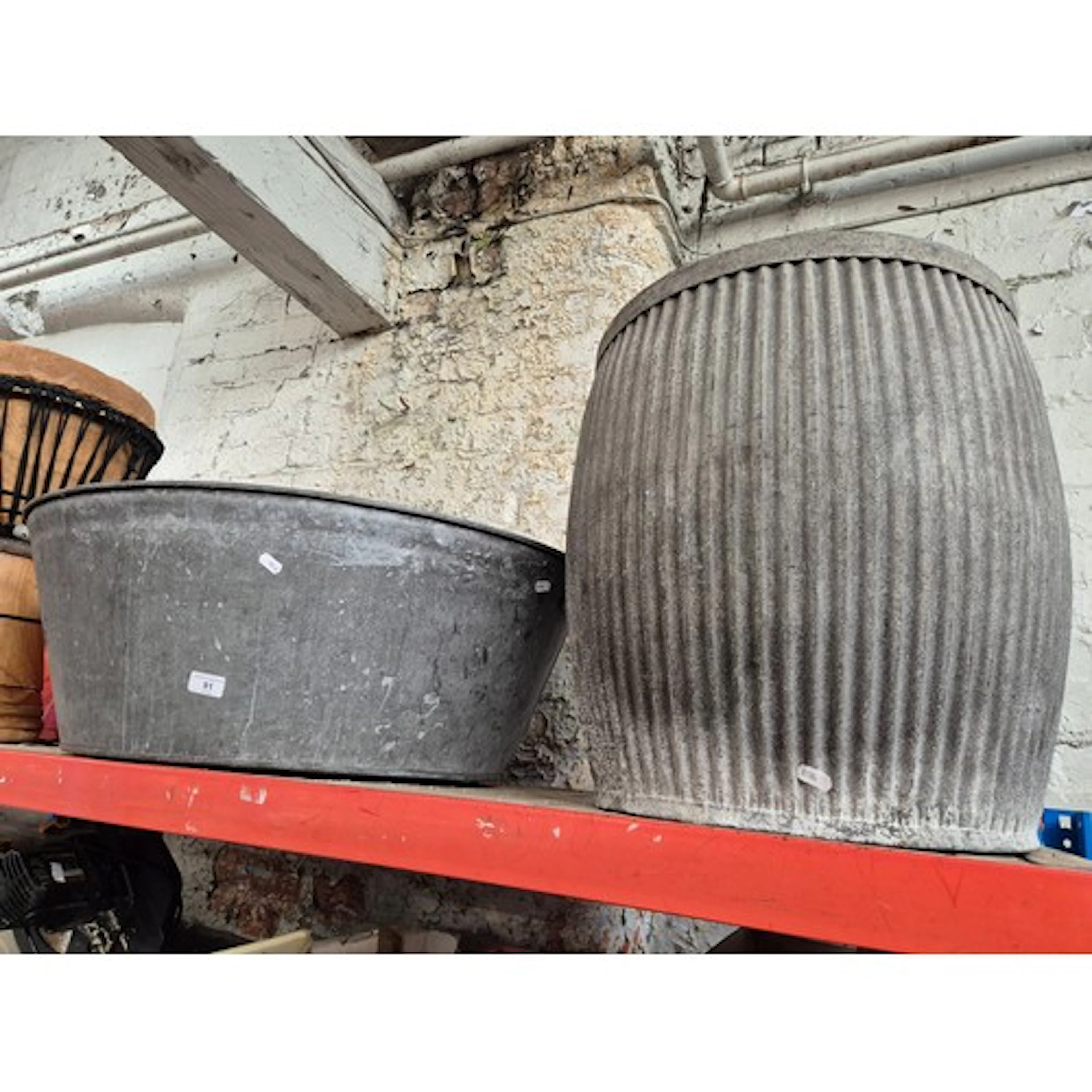 A dolly tub and a galvanised oval metal tub.