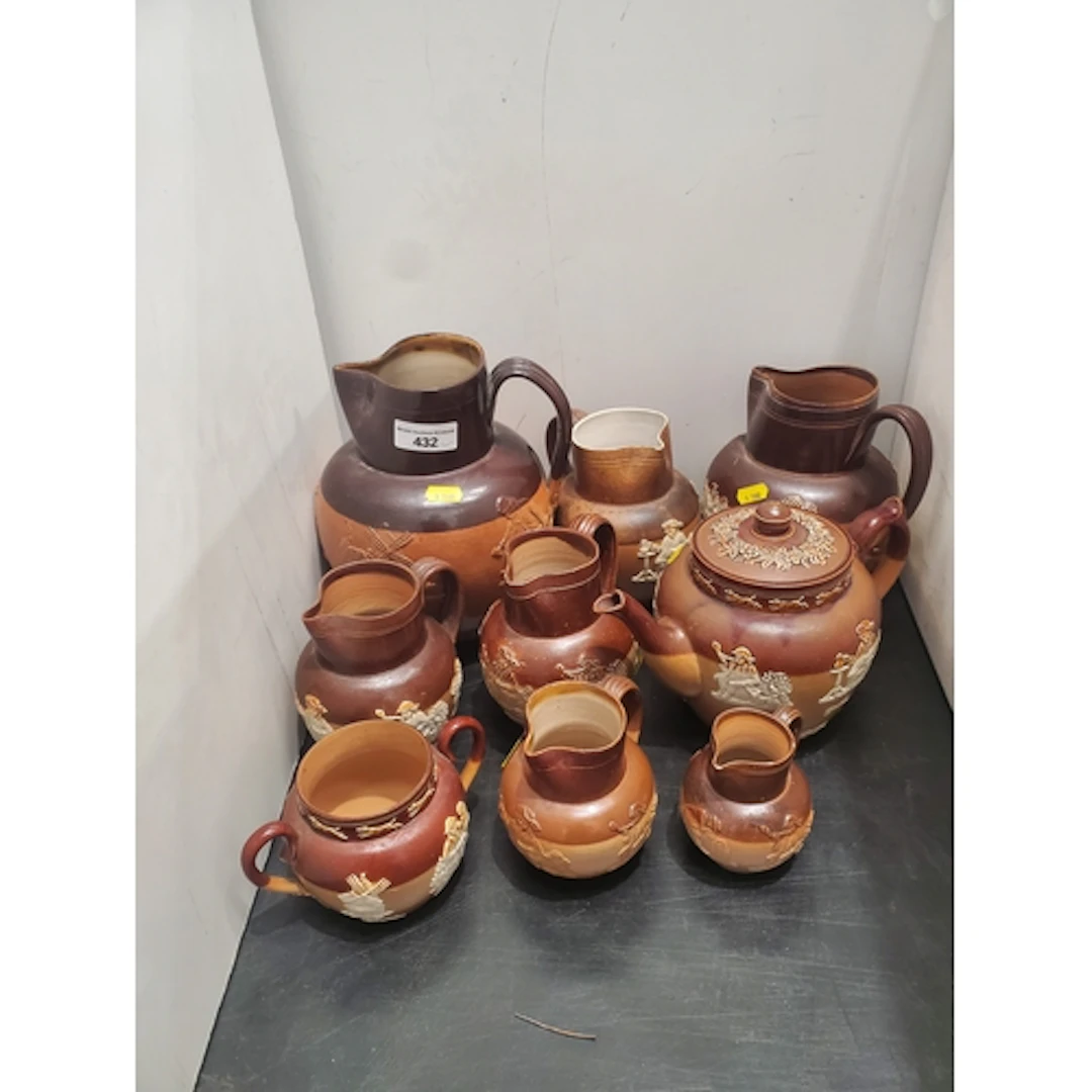 A collection of nine Doulton Lambeth stoneware Jugs, Sugar B...