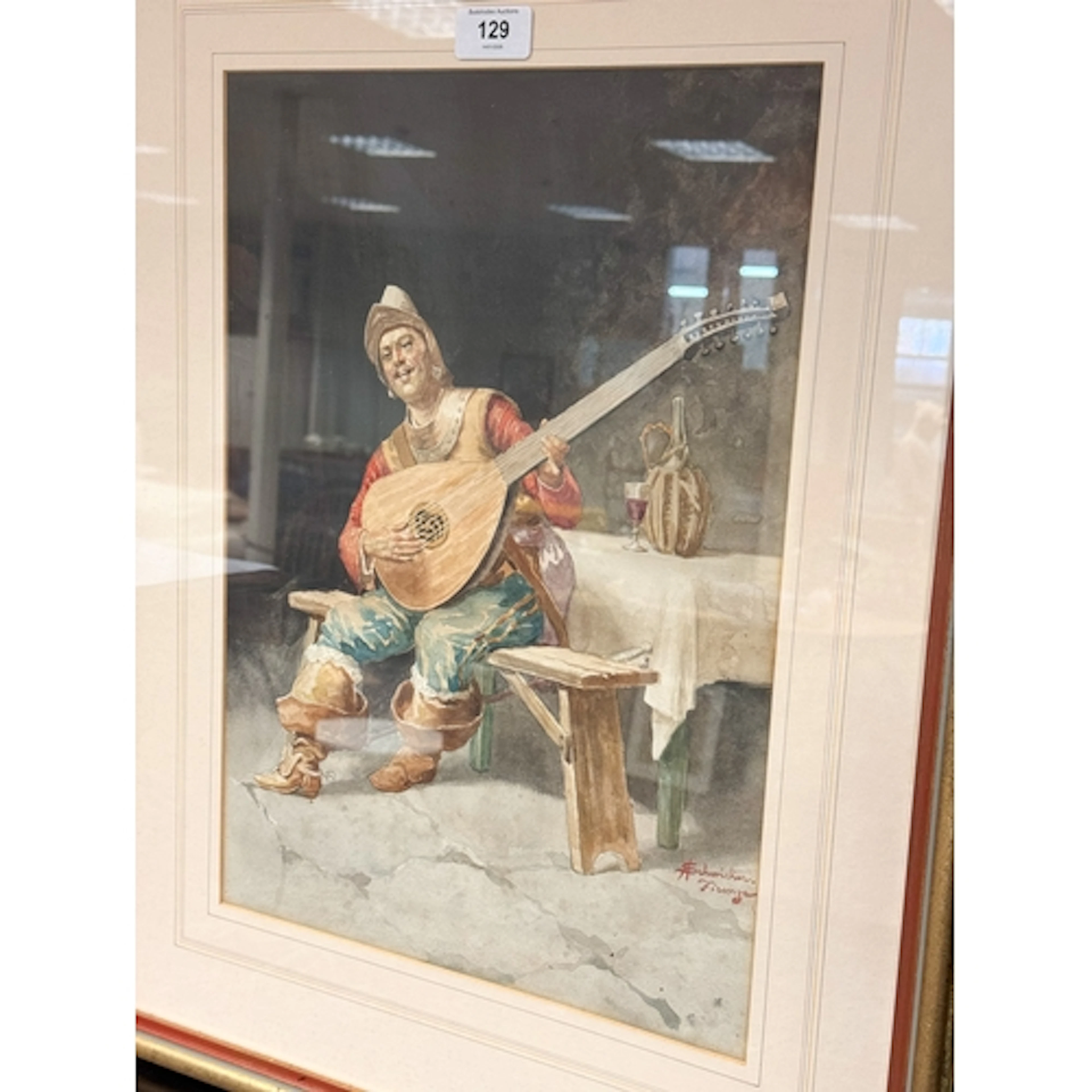 A gilt framed watercolour of a mandolin player signed Amelio...