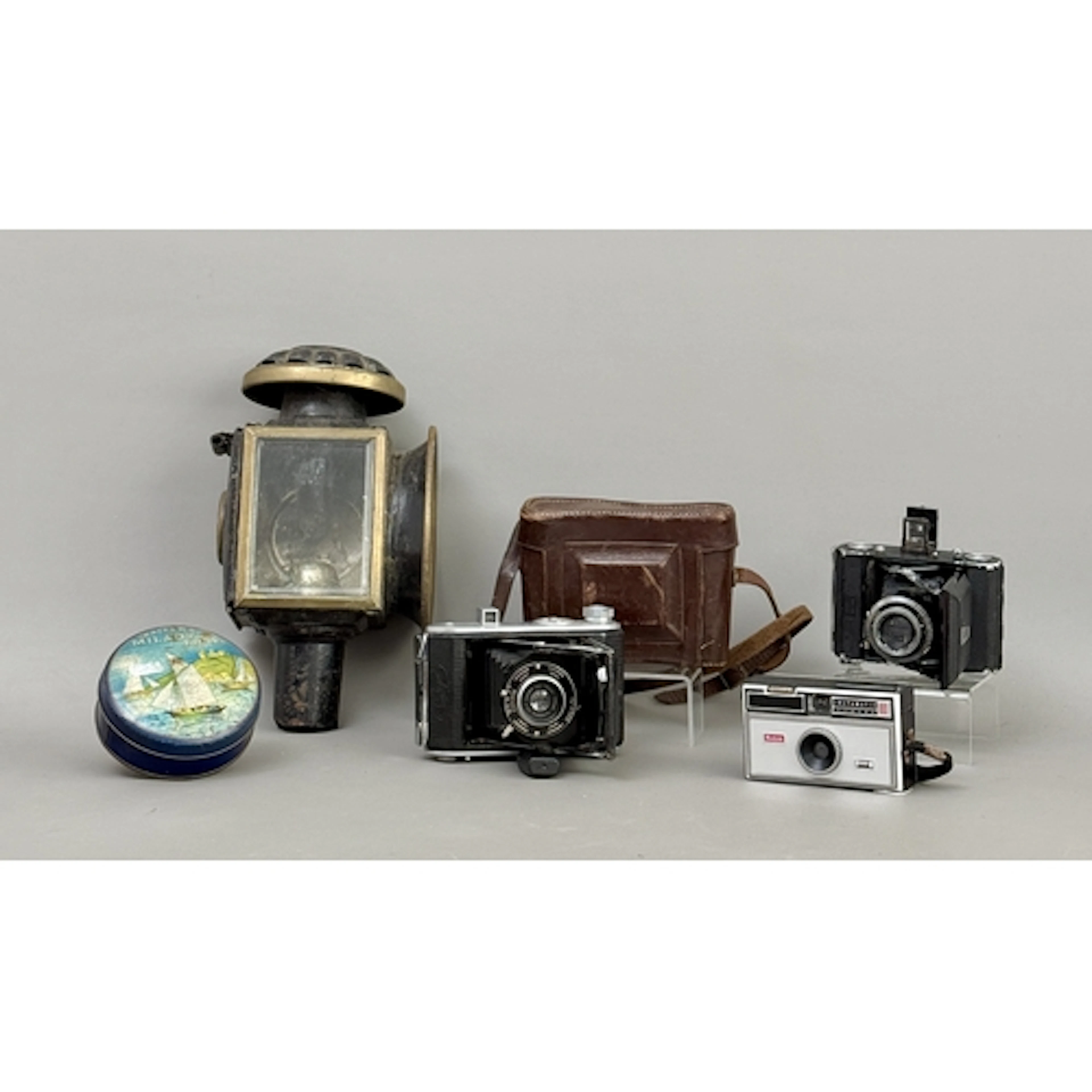 A small group of collectables - comprising a brass and black...