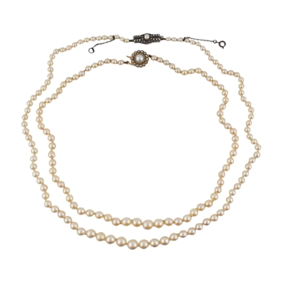 Two early 20th century single strand pearl necklaces. A neck...