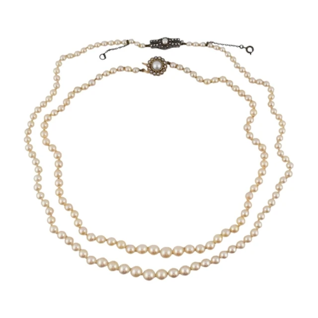Two early 20th century single strand pearl necklaces. A neck...