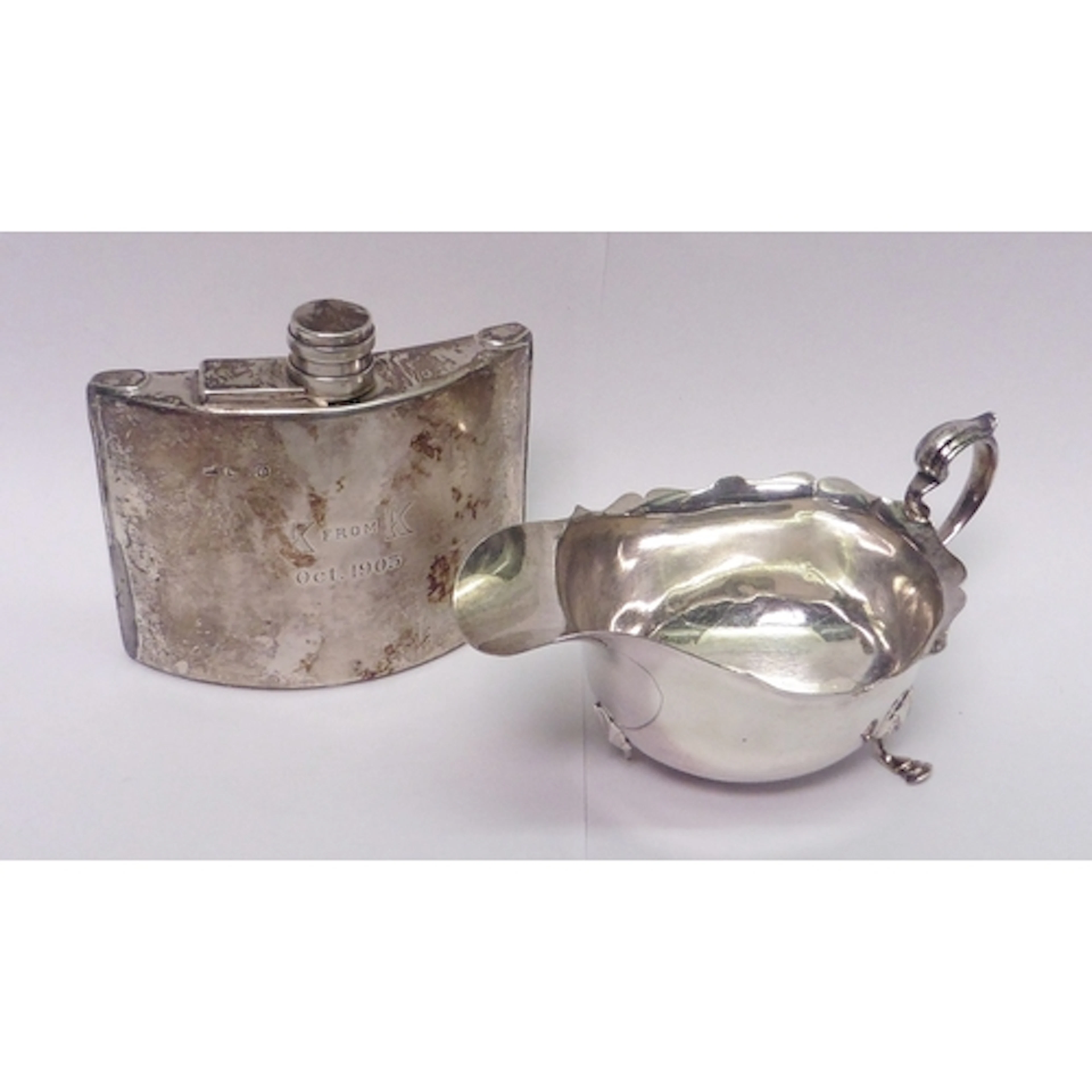 A silver sauce boat, A/F dented and missing a foot; a silver...