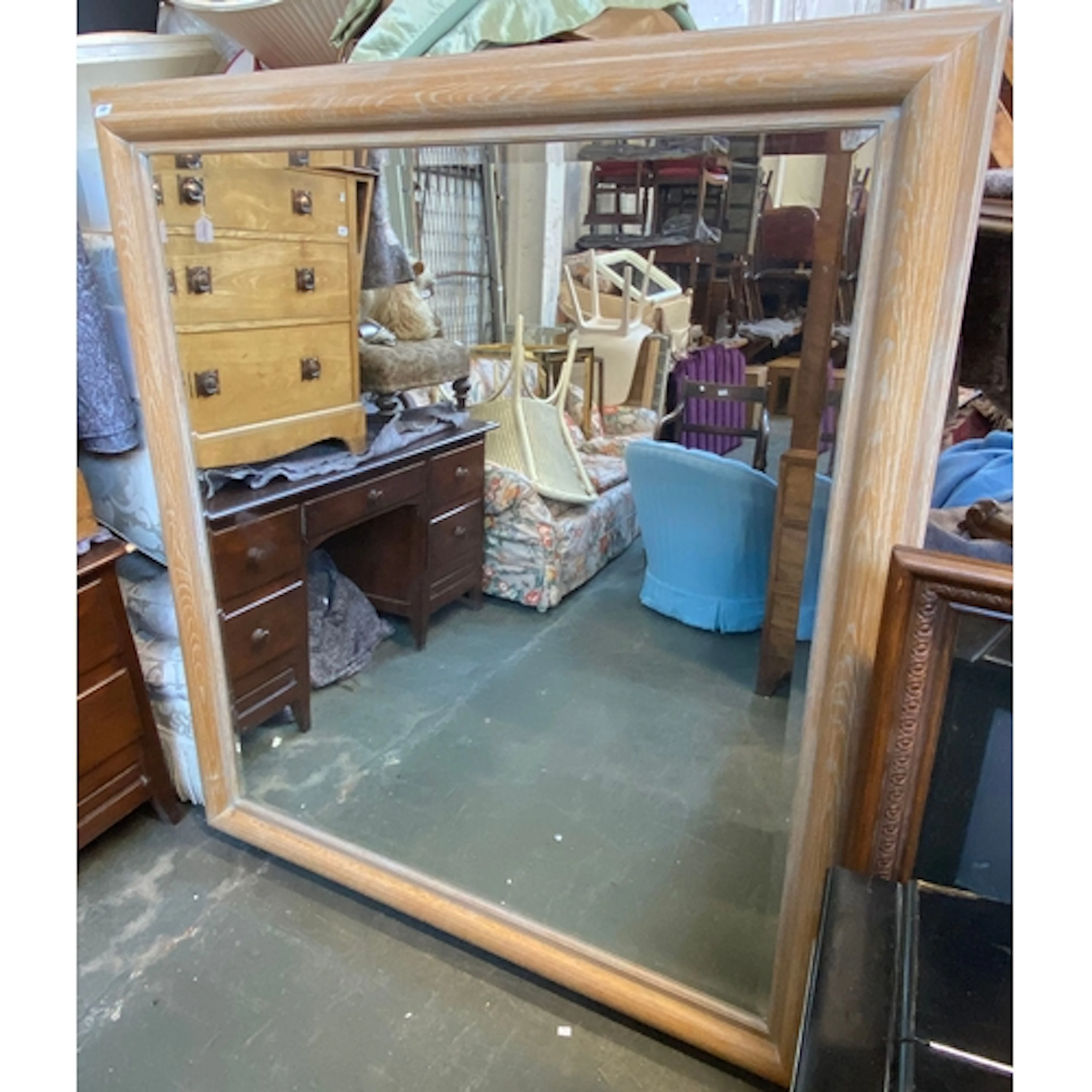 A very large modern square mirror with limed oak cushion fra...