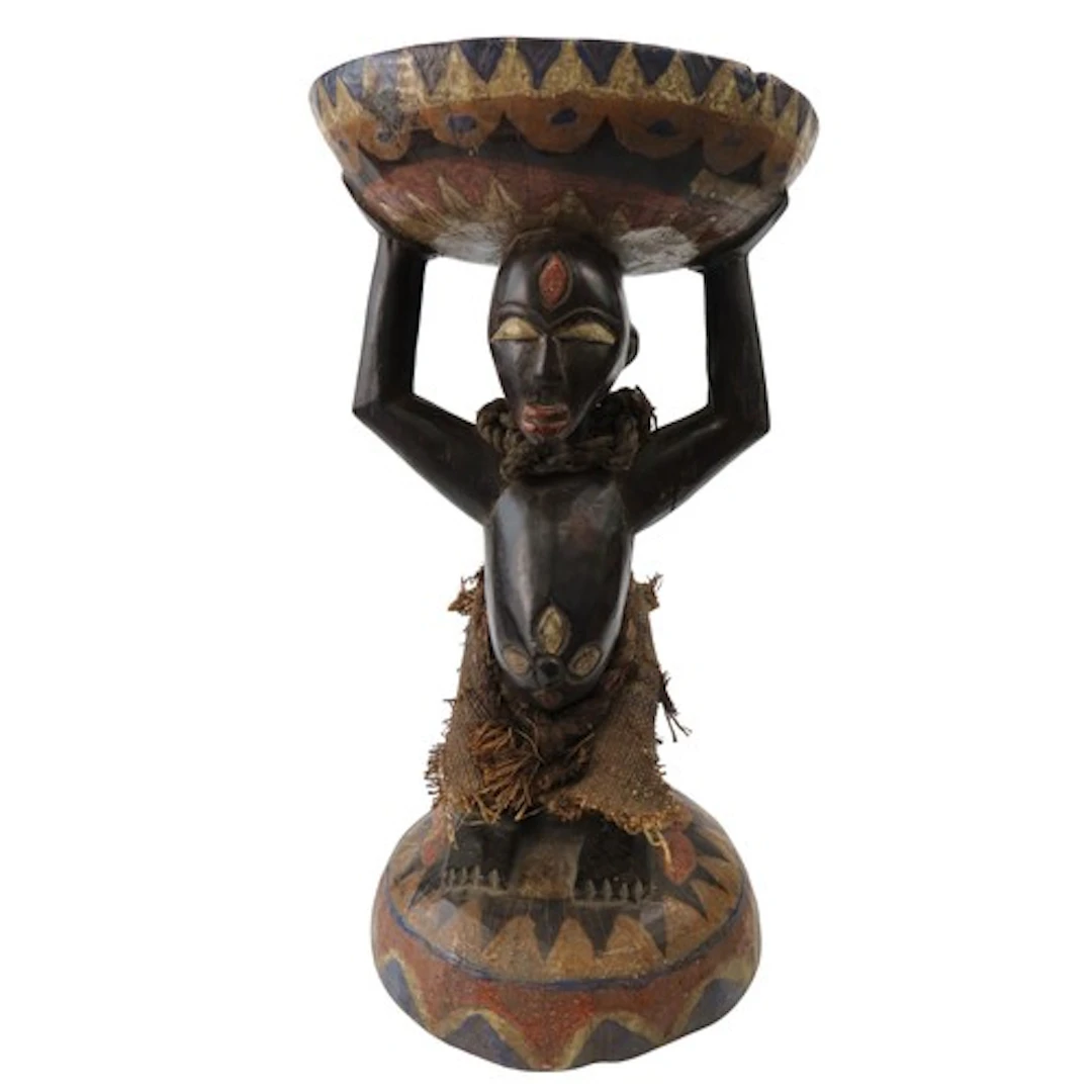 A FINE LUBA STOOL, the circular stop supported by a male fig...