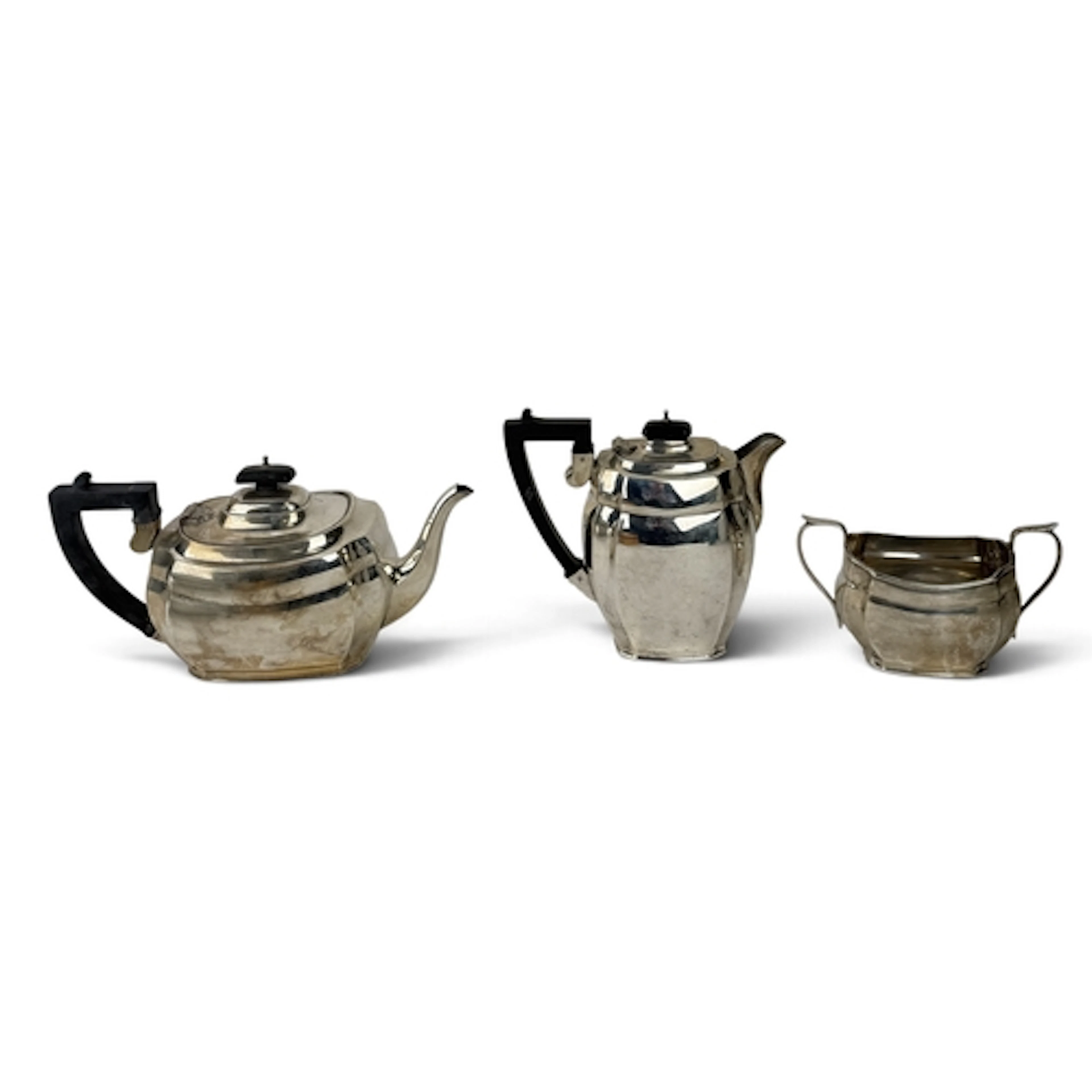 A SILVER THREE PIECE TEA SERVICE Comprising tea pot, coffee ...
