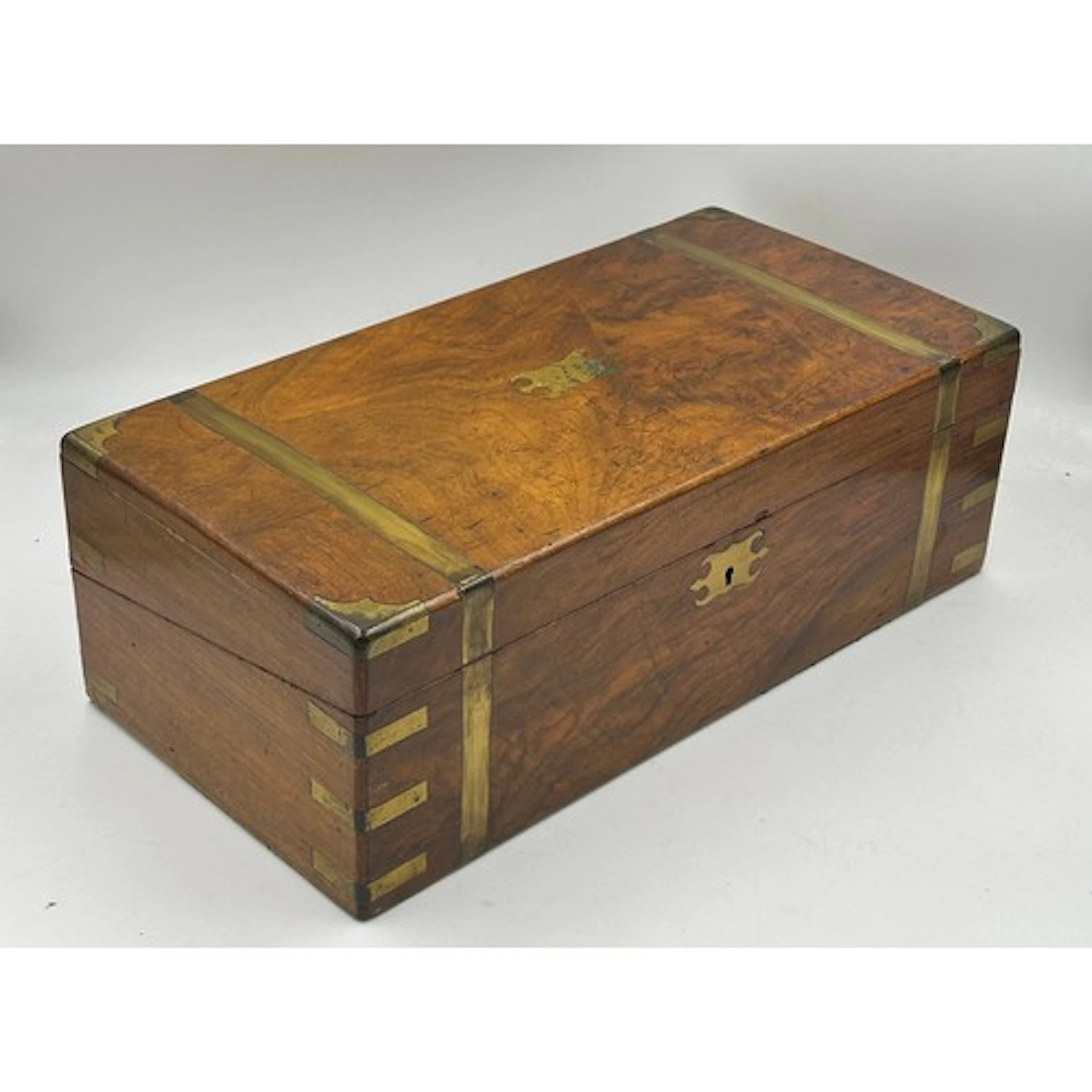 A 19thC writing slope in walnut and mahogany with brass band...