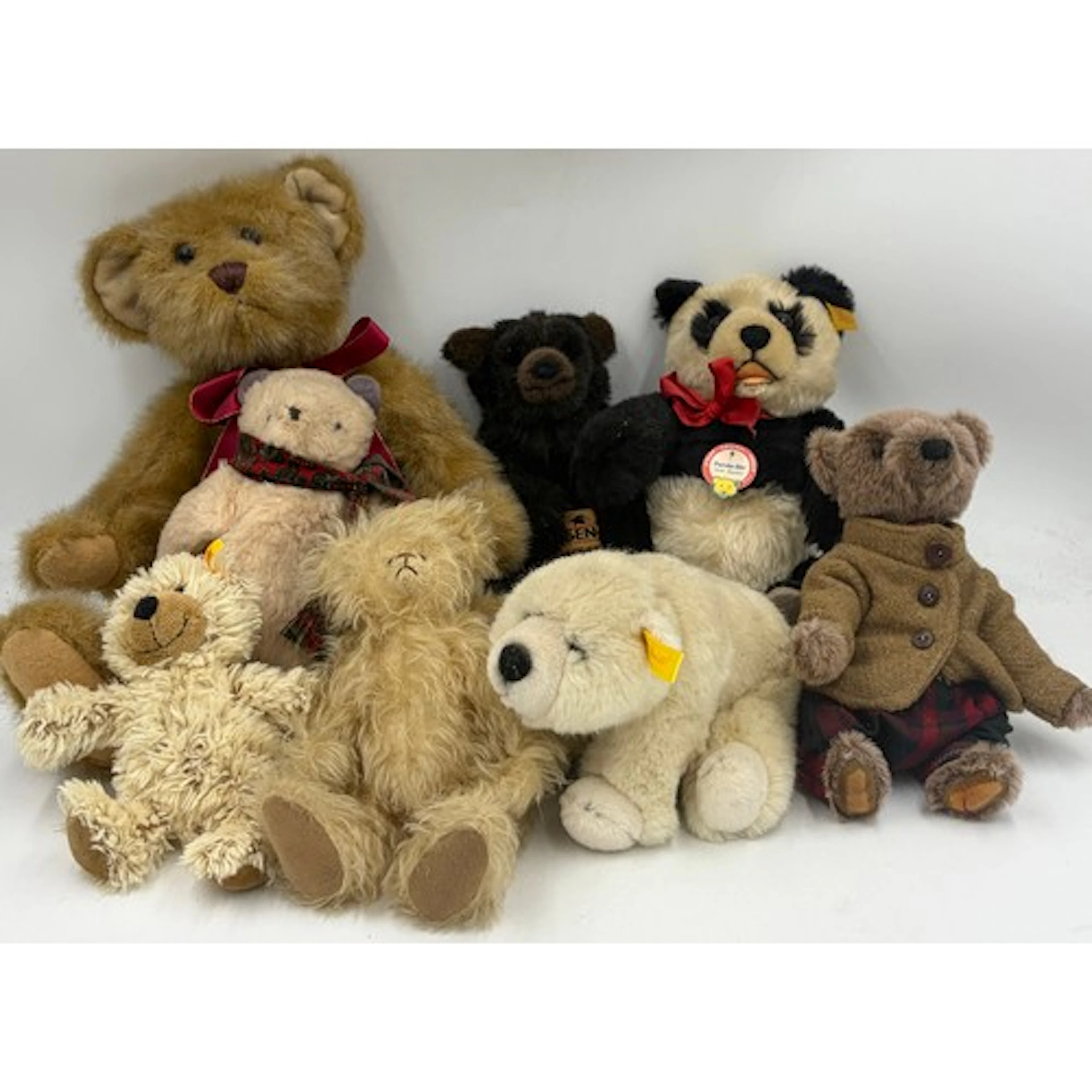 A collection of soft toys to include Steiff Panda Bear repli...