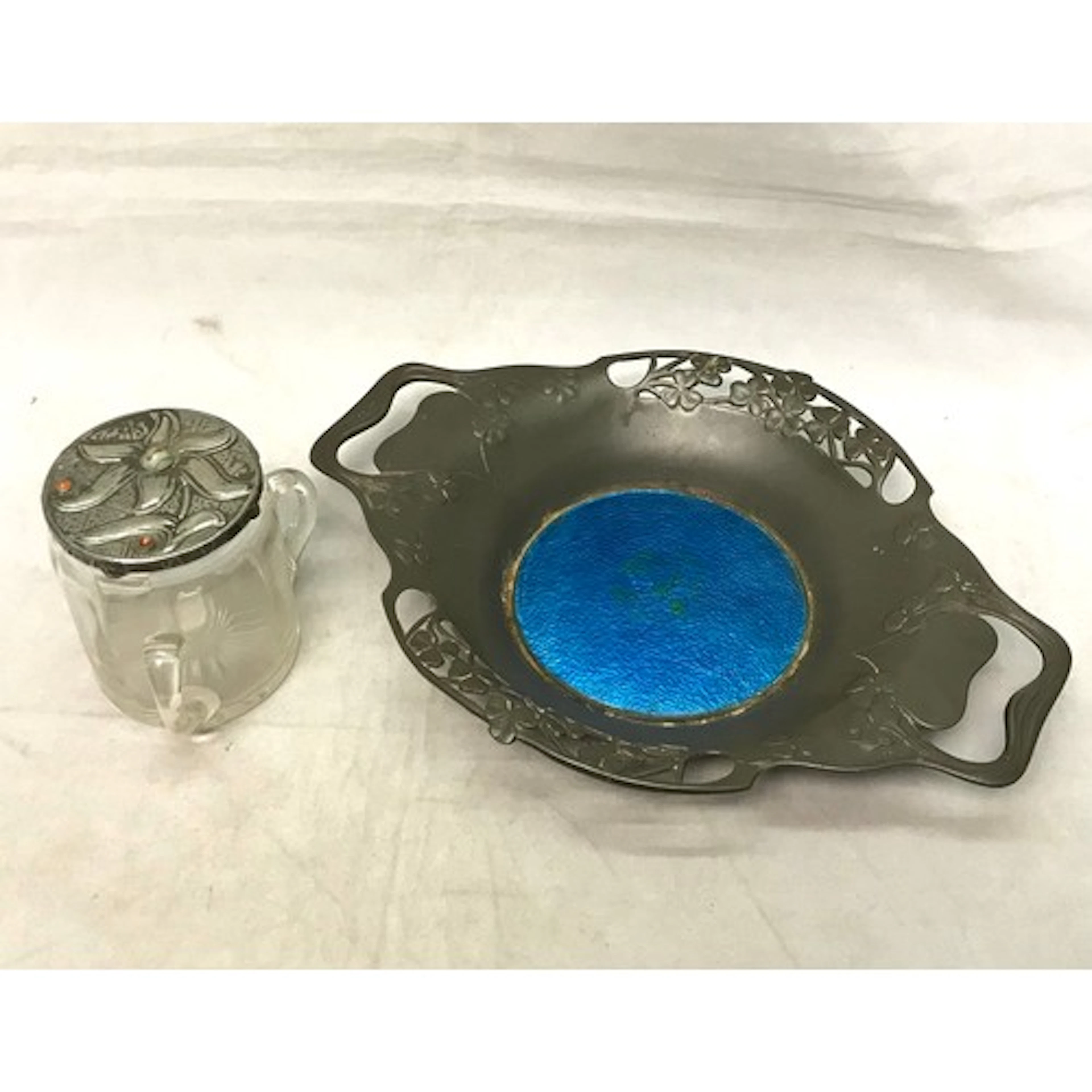 An Art Nouveau influence two handled pewter dish with an ena...