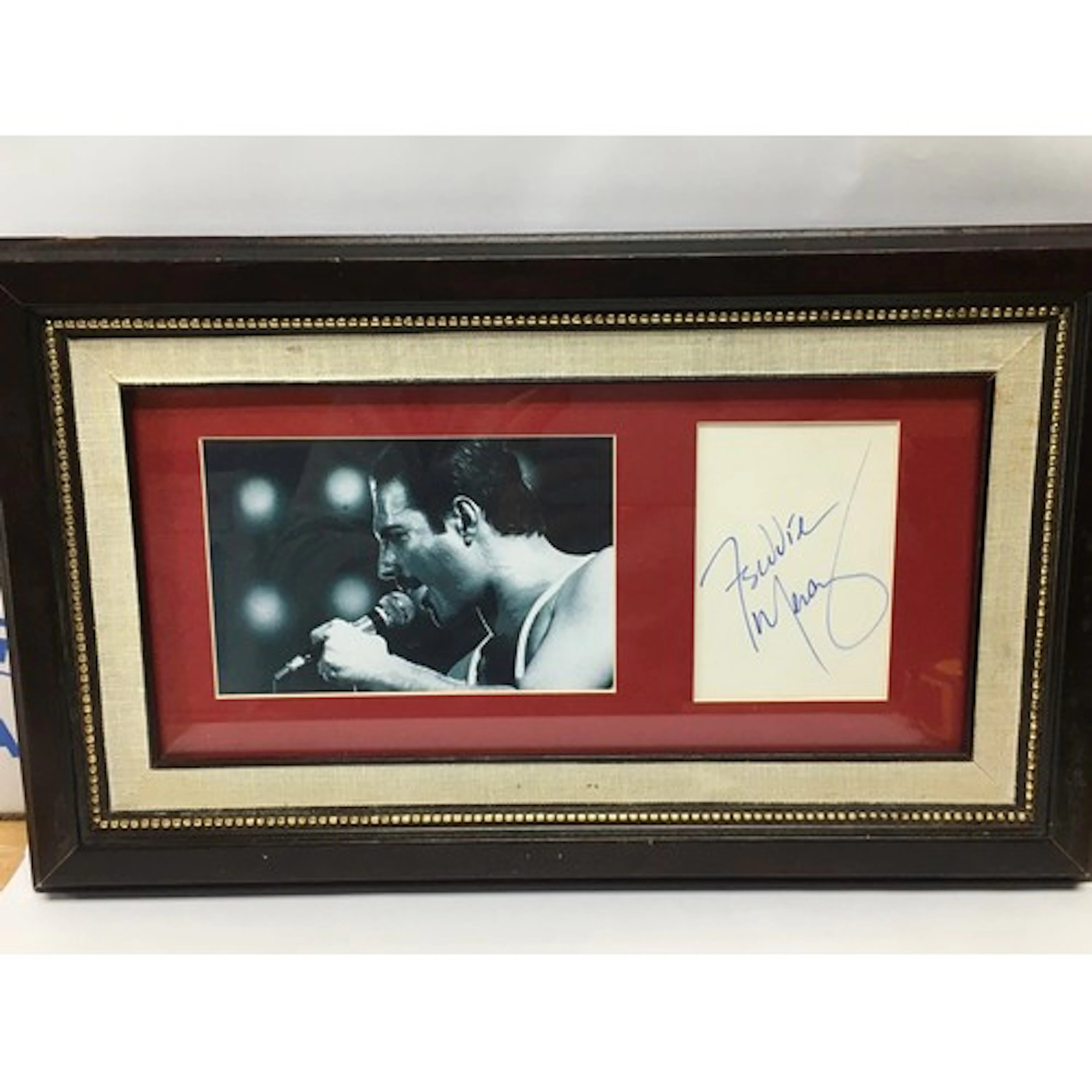 A framed and glazed Freddie Mercury autograph and photo with...