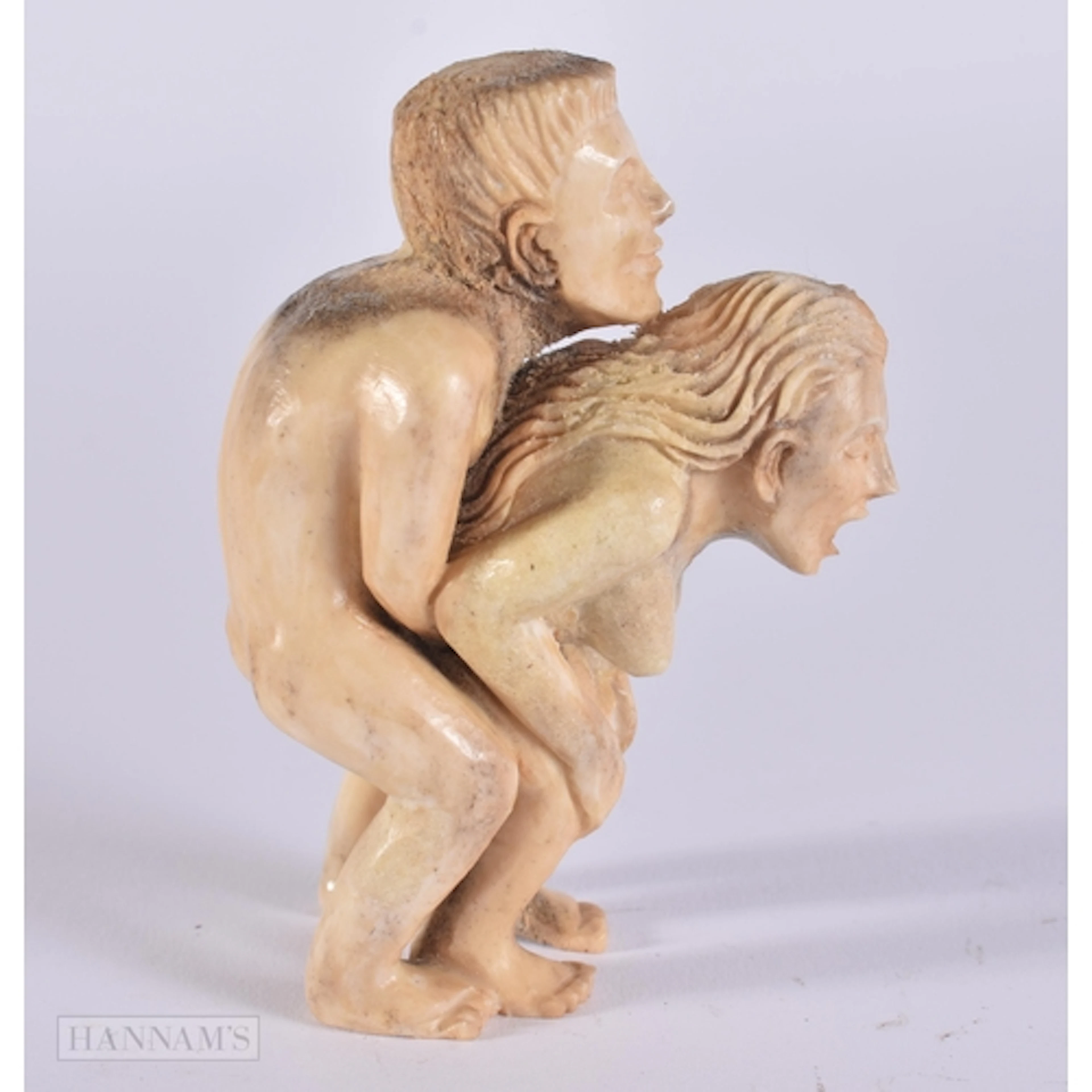 A BONE EROTIC NETSUKE. 8.2 x 5.7 x 3.2 cm.