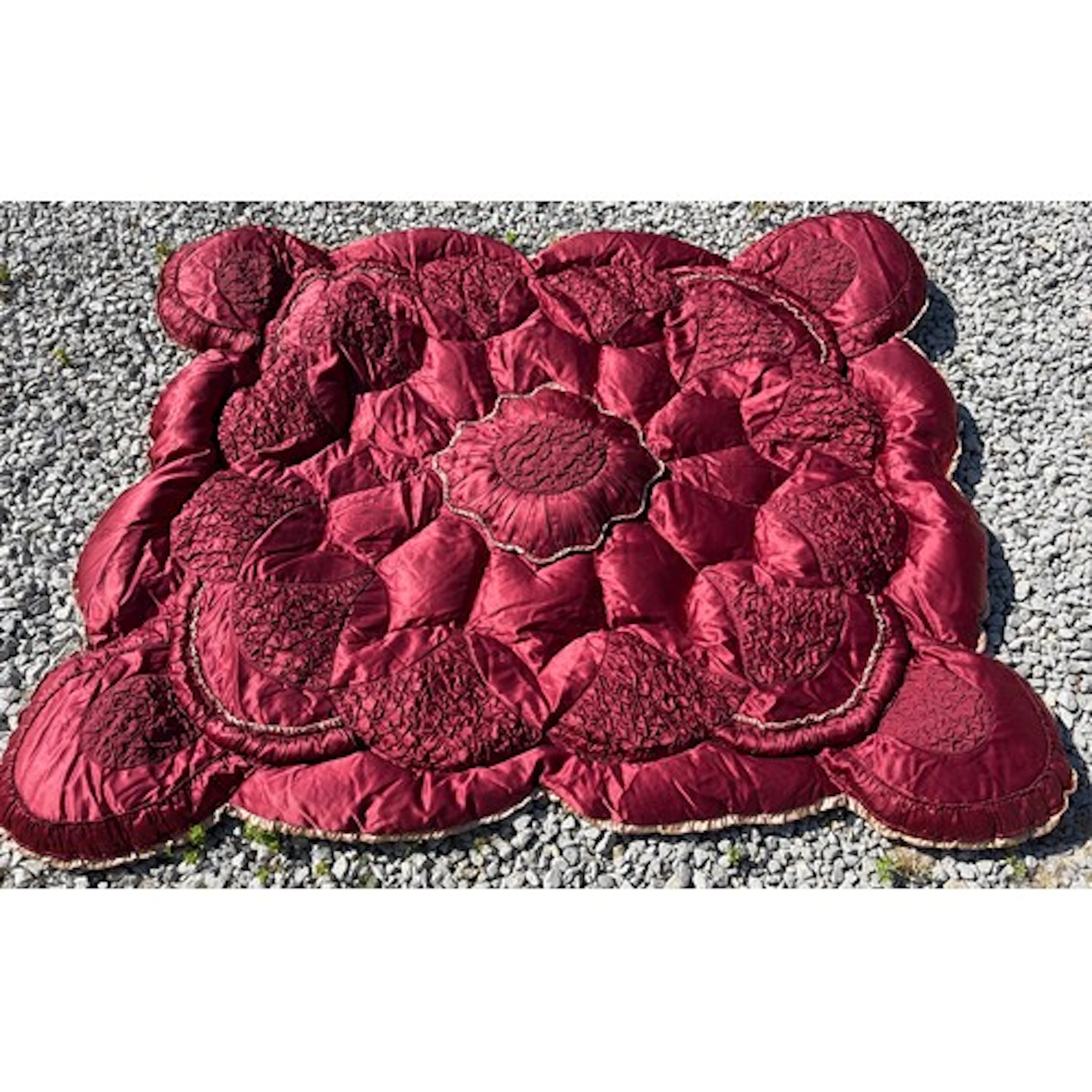 A 1930's/1950's vintage quilted eiderdown in claret satin wi...