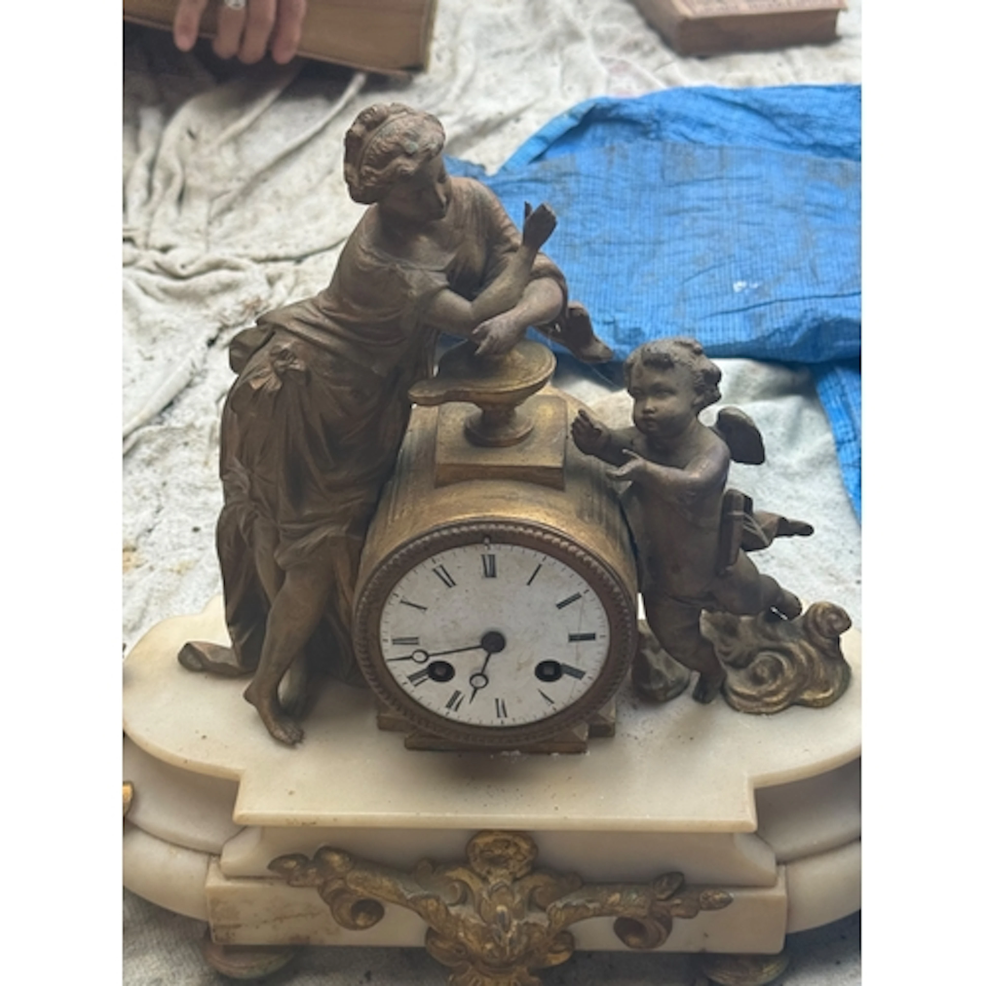 A FRENCH ALABASTER AND SPELTER MANTLE CLOCK Surmounted with ...