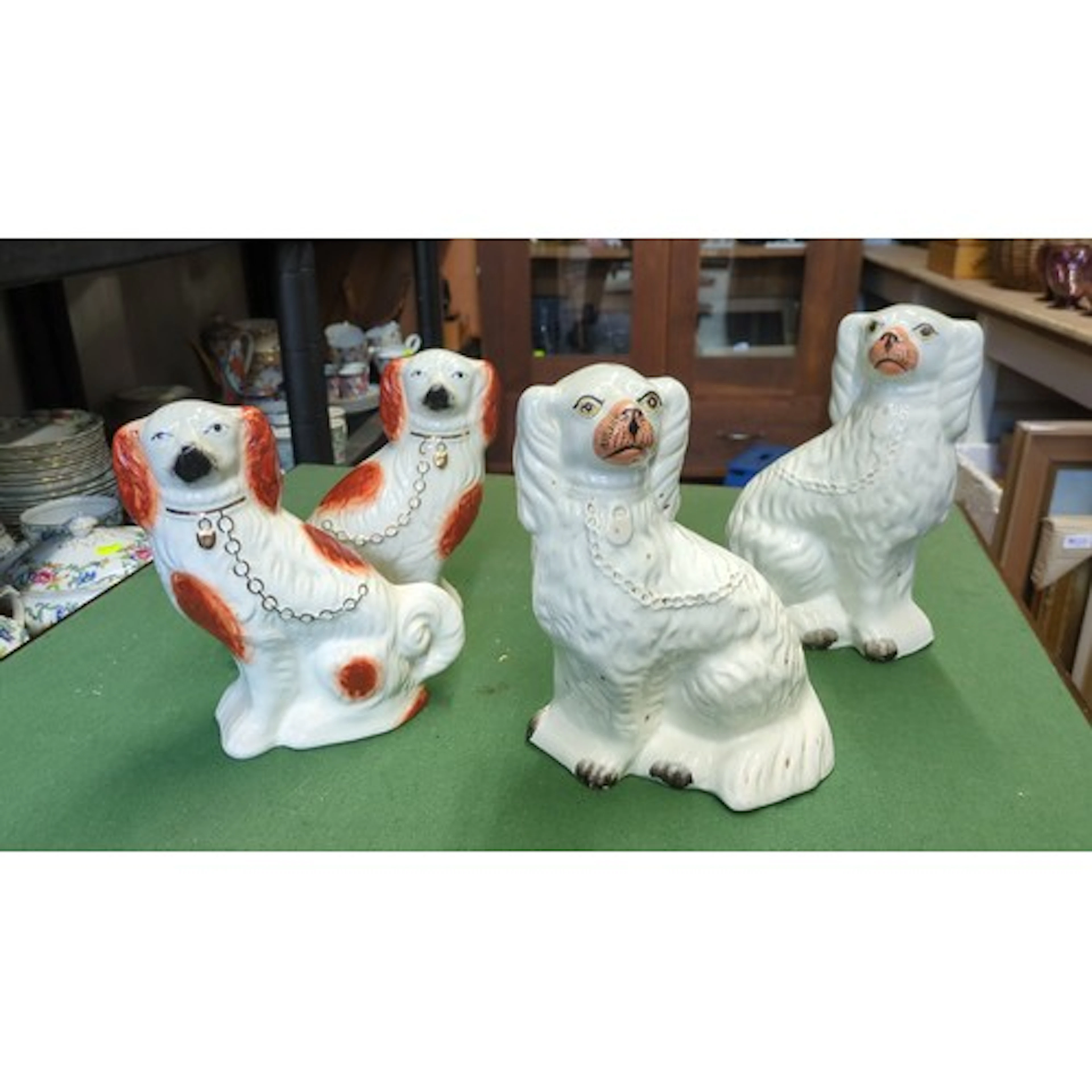 A group of four Staffordshire-style glazed earthenware spani...