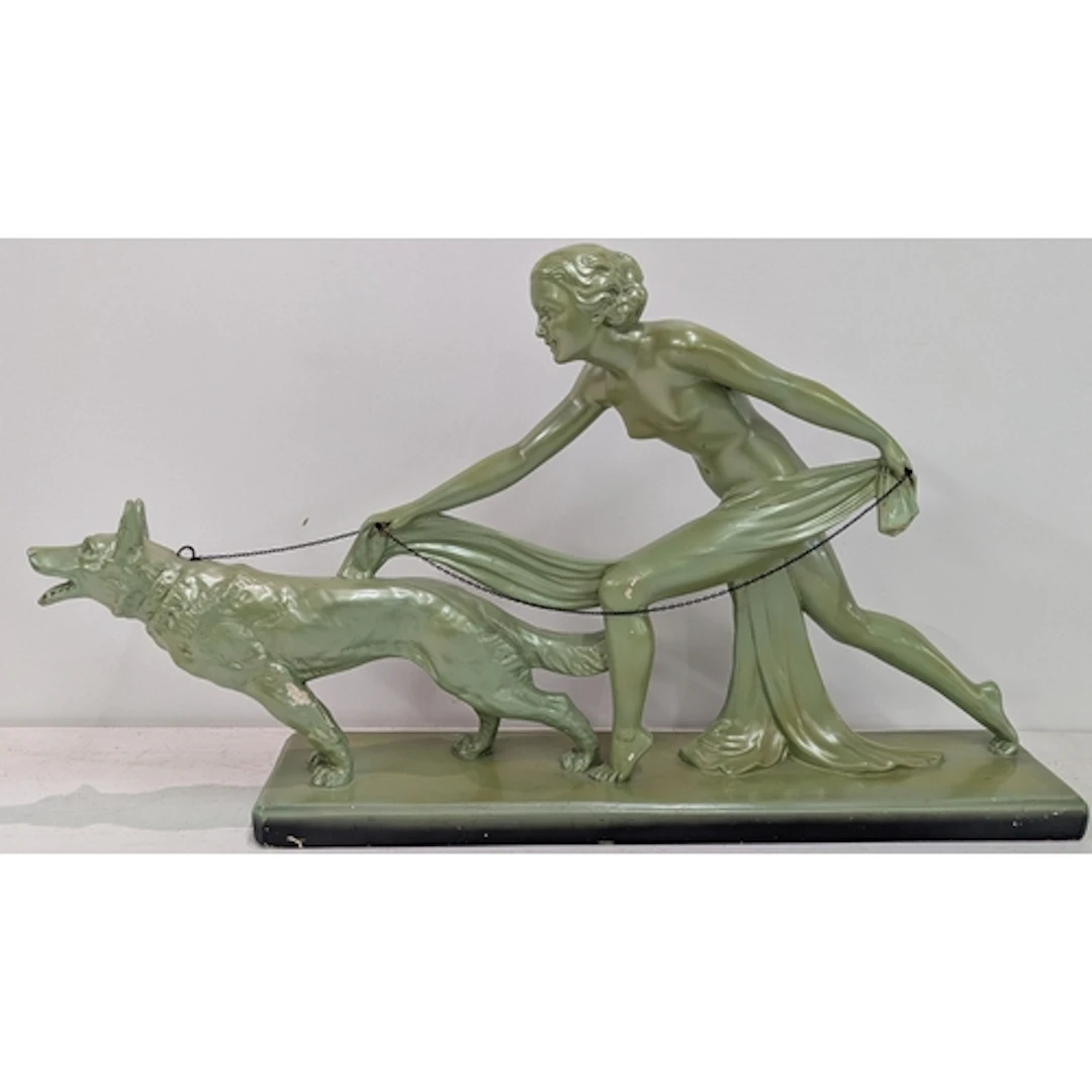 An Art Deco plaster figural group of a draped woman walking ...