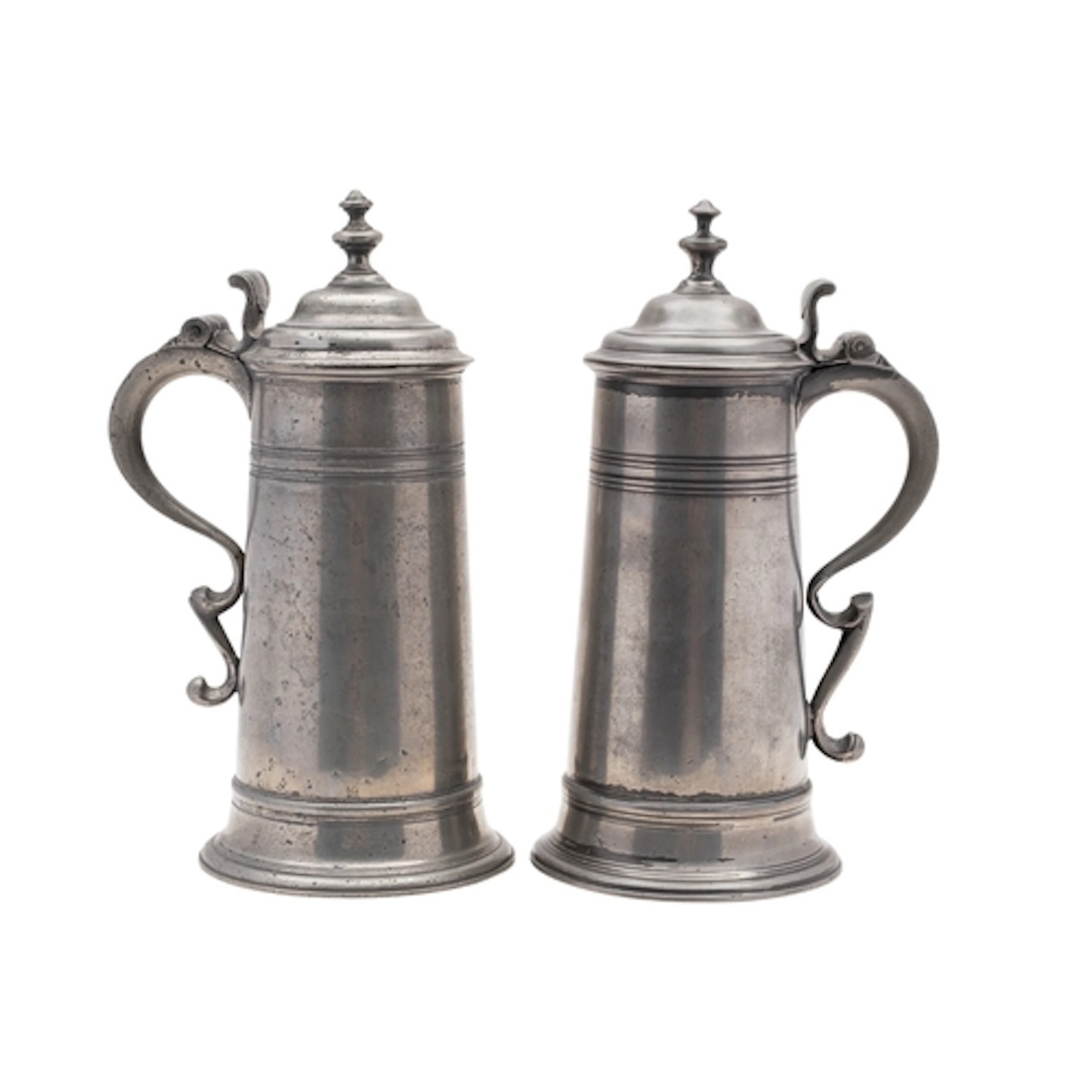 Two similar George III pewter spire flagons, circa 1760; one...